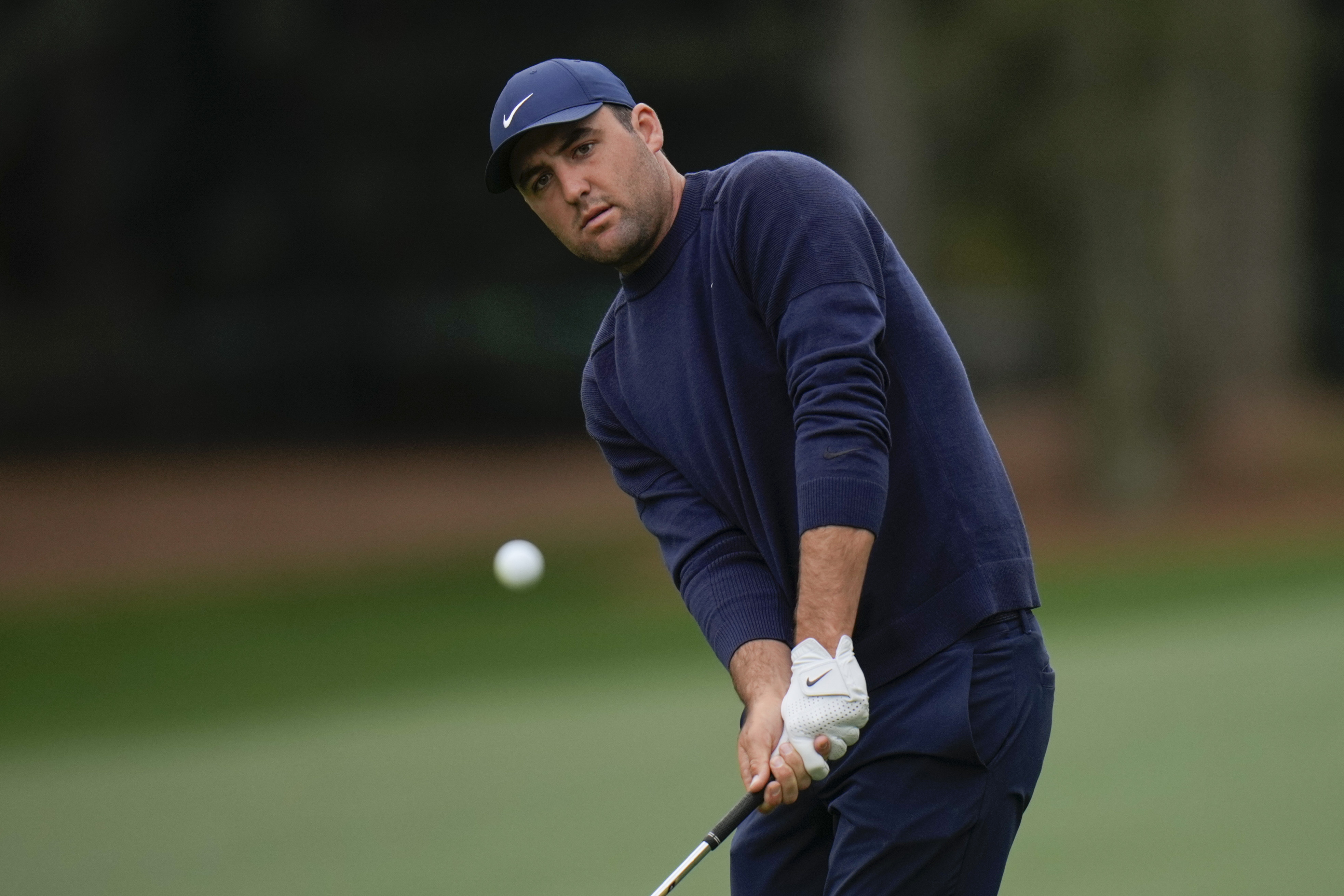 Scottie Scheffler chips to the 14th green during the second round at the Masters golf tournament on Friday, April 8, 2022, in Augusta, Ga.