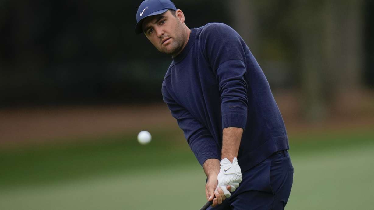 Scottie Scheffler chips to the 14th green during the second round at the Masters golf tournament on Friday, April 8, 2022, in Augusta, Ga.