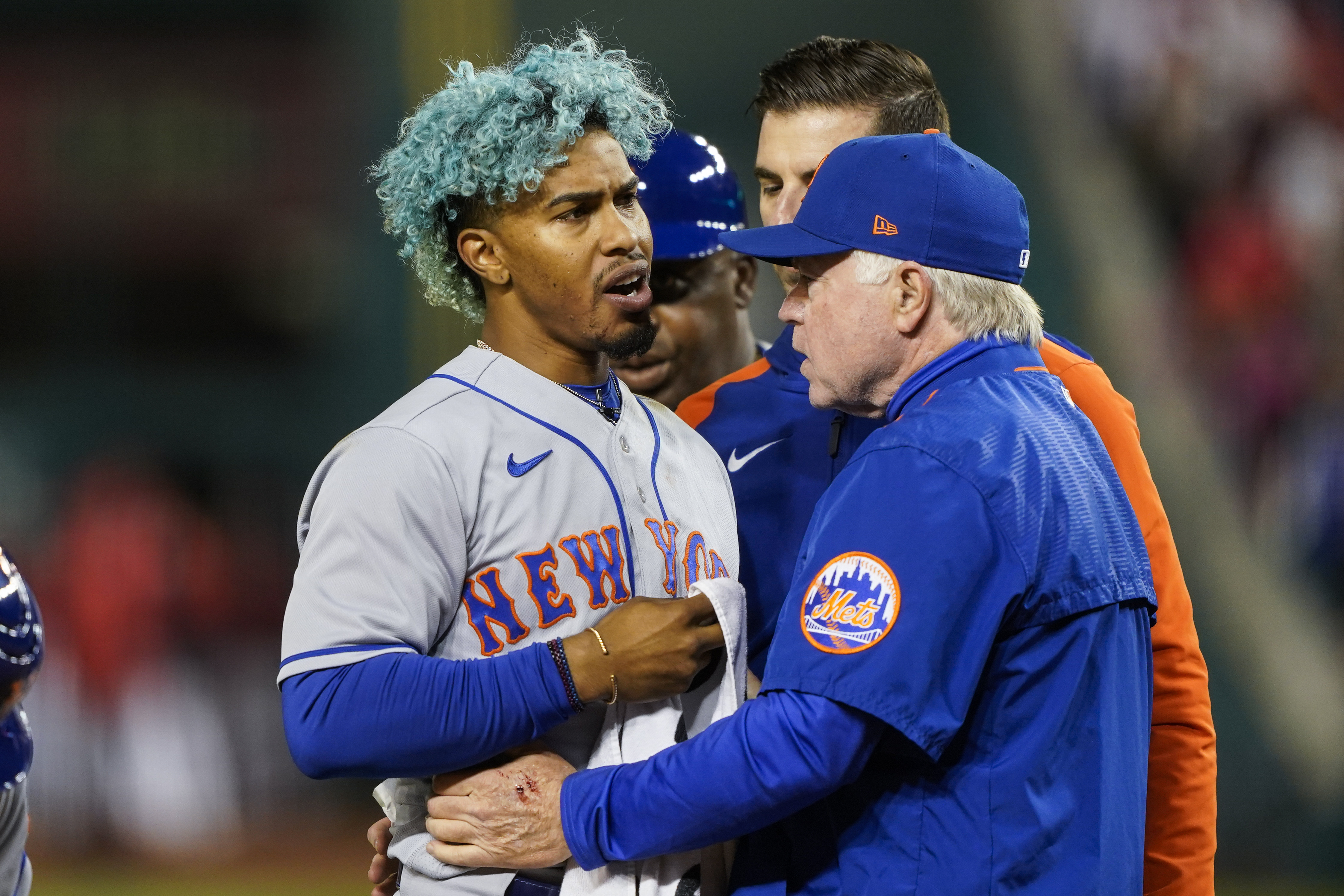 New York Mets shortstop Francisco Lindor, left, is pulled from the game by manager Buck Showalter, right, after he was hit by a pitch during the fifth inning of a baseball game against the Washington Nationals at Nationals Park, Friday, April 8, 2022, in Washington. 
