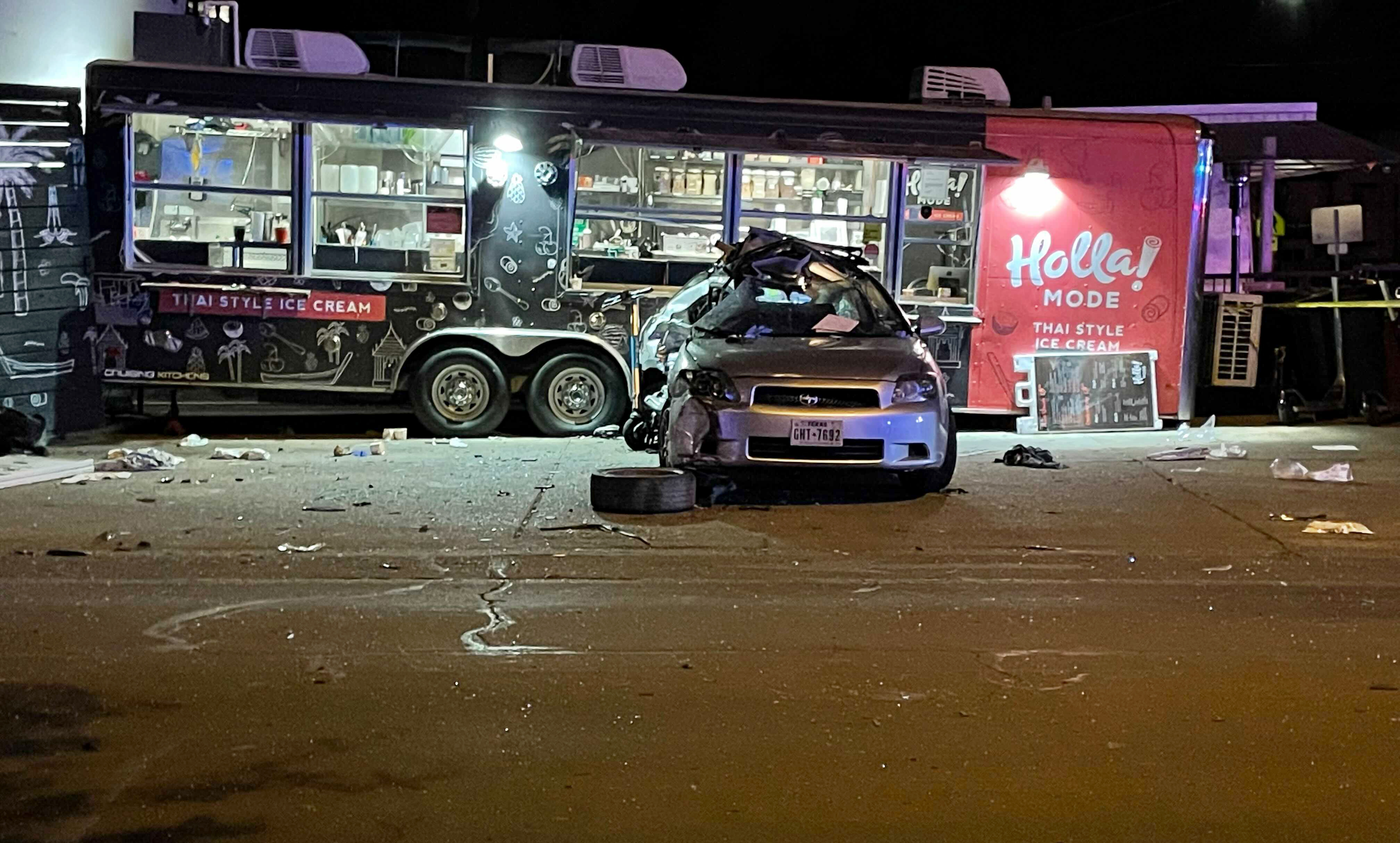 A damaged vehicle sits in front of a food truck following a collision in Austin, Texas on April 8. Authorities say multiple people were injured in the "major collision” involving pedestrians and two vehicles, one of which hit the food truck.