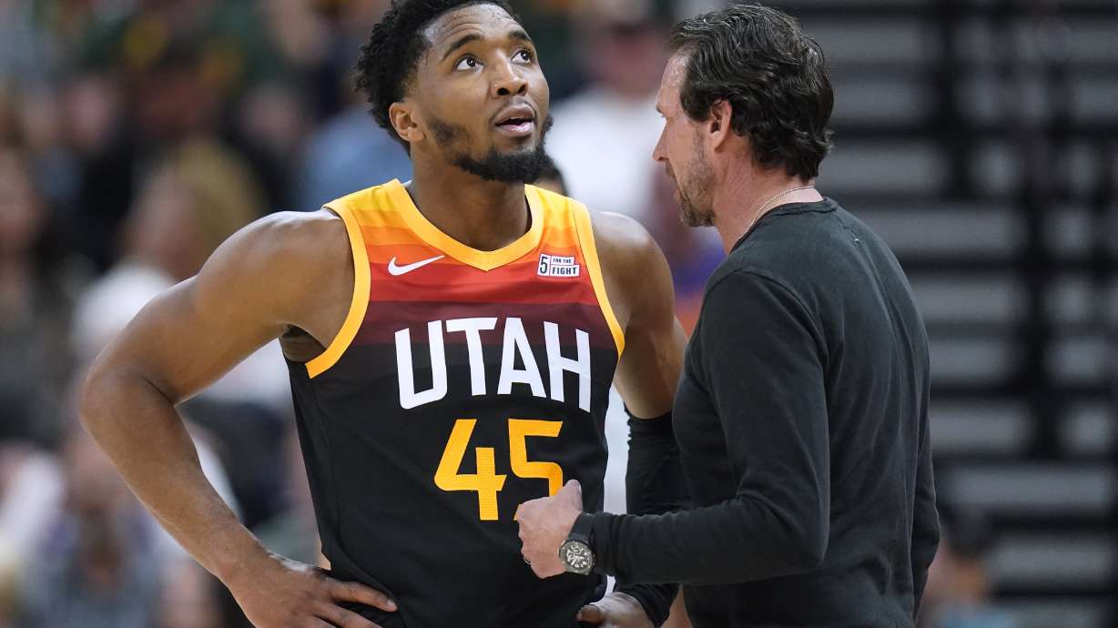 Utah Jazz's Donovan Mitchell (45) speaks with coach Quin Snyder during the second half of the team's NBA basketball game against the Phoenix Suns on Friday, April 8, 2022, in Salt Lake City.