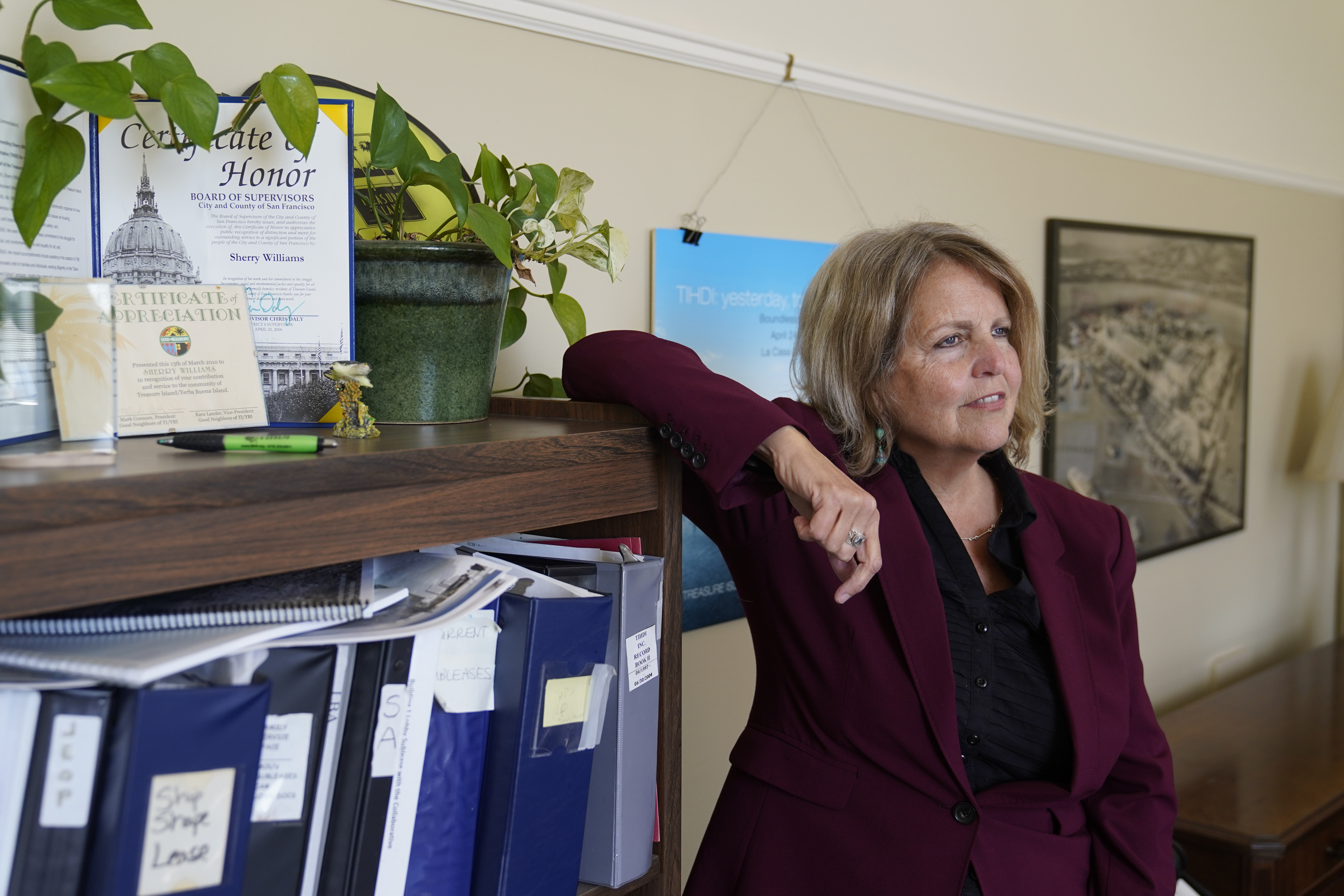 Sherry Williams, executive director of One Treasure Island, poses for a photo her office on Tuesday, in San Francisco. In the case of Williams, the San Francisco nonprofit director, thieves hacked the email account of the nonprofit's bookkeeper then inserted themselves into a long email thread, sent messages asking to change the wire payment instructions for a grant recipient, and made off with $650,000.