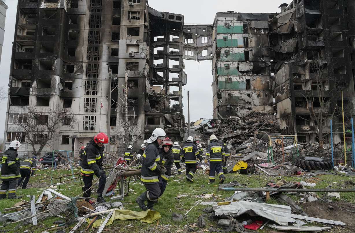 Emergency workers carry debris from a multi-story building destroyed in a Russian air raid at the beginning of the Russia-Ukraine war in Borodyanka, close to Kyiv, Ukraine, Saturday.