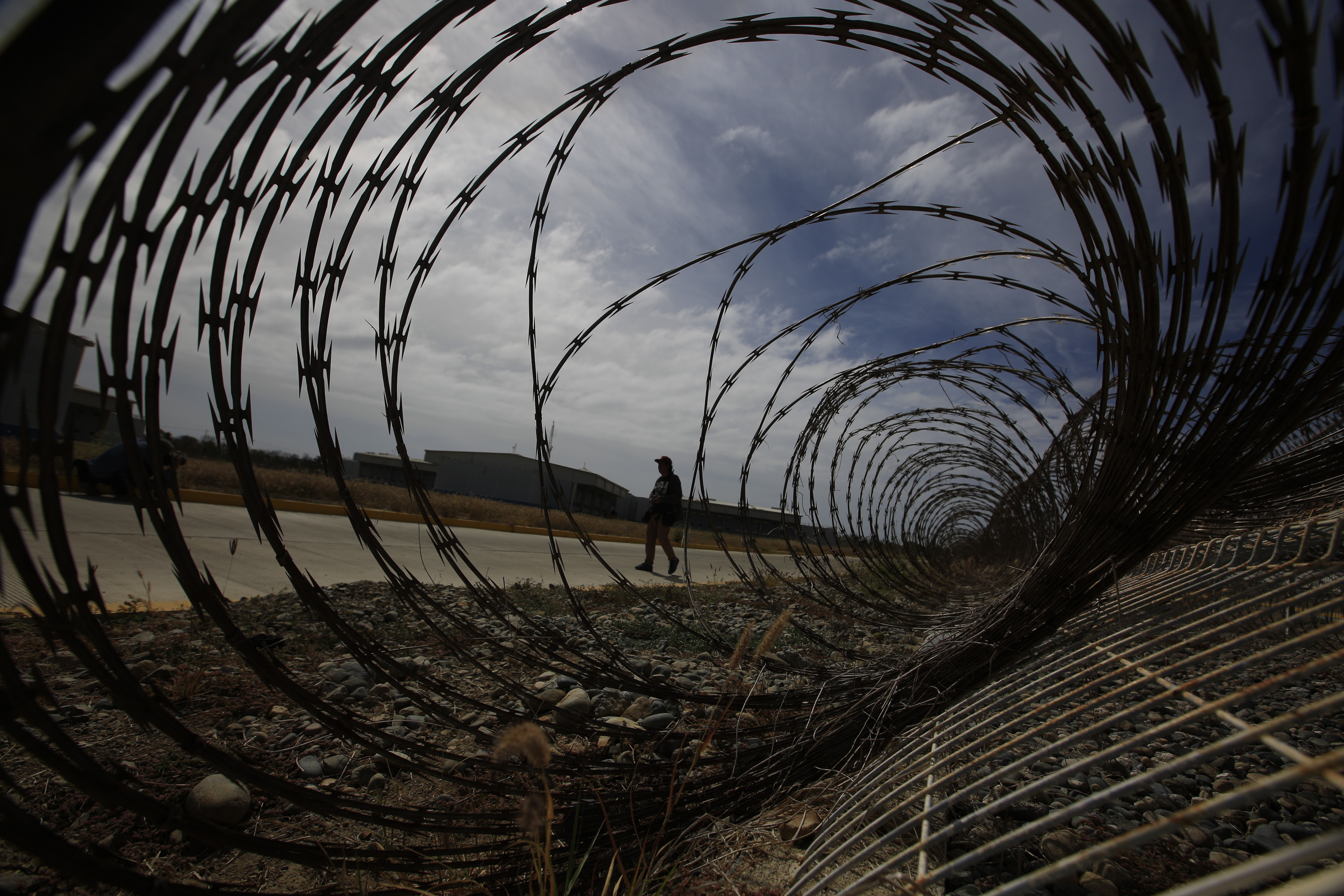 A journalist walks past a fallen section of fencing during a media tour of the now closed Laguna del Toro maximum security facility on the former Islas Marias penal colony located off Mexico's Pacific coast, March 16, 2019.