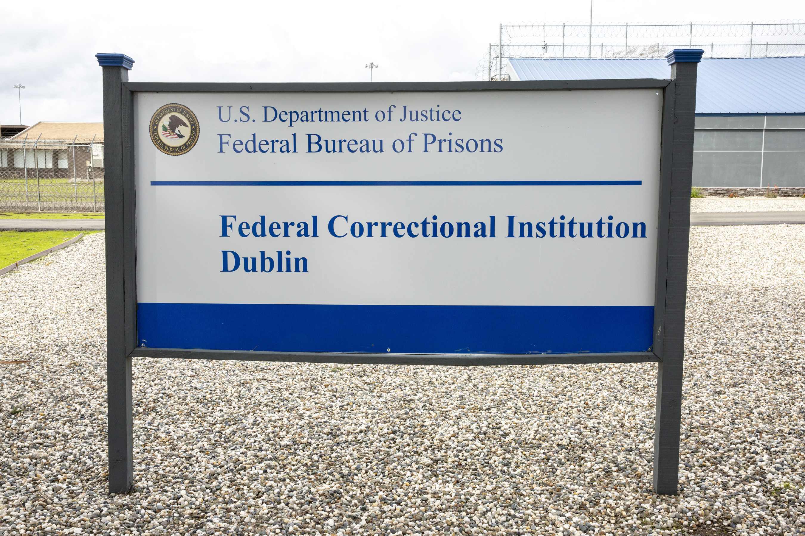 A sign for the Federal Correctional Institution Dublin is displayed on Jan. 9, 2019, in Dublin, Calif. A government watchdog has found a “substantial likelihood” the federal Bureau of Prisons committed wrongdoing when it ignored complaints and failed to address asbestos and mold contamination at the federal women’s prison that has already been under scrutiny. 