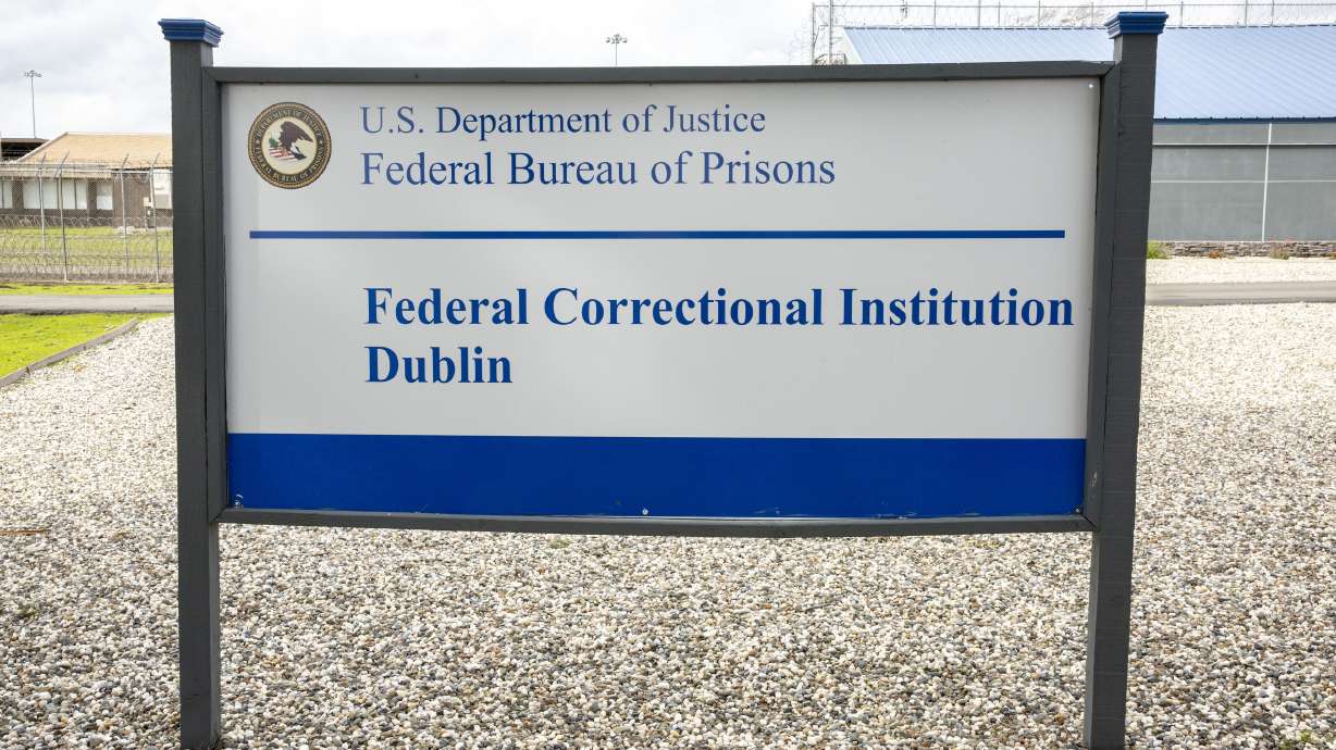 A sign for the Federal Correctional Institution Dublin is displayed on Jan. 9, 2019, in Dublin, Calif. A government watchdog has found a “substantial likelihood” the federal Bureau of Prisons committed wrongdoing when it ignored complaints and failed to address asbestos and mold contamination at the federal women’s prison that has already been under scrutiny.