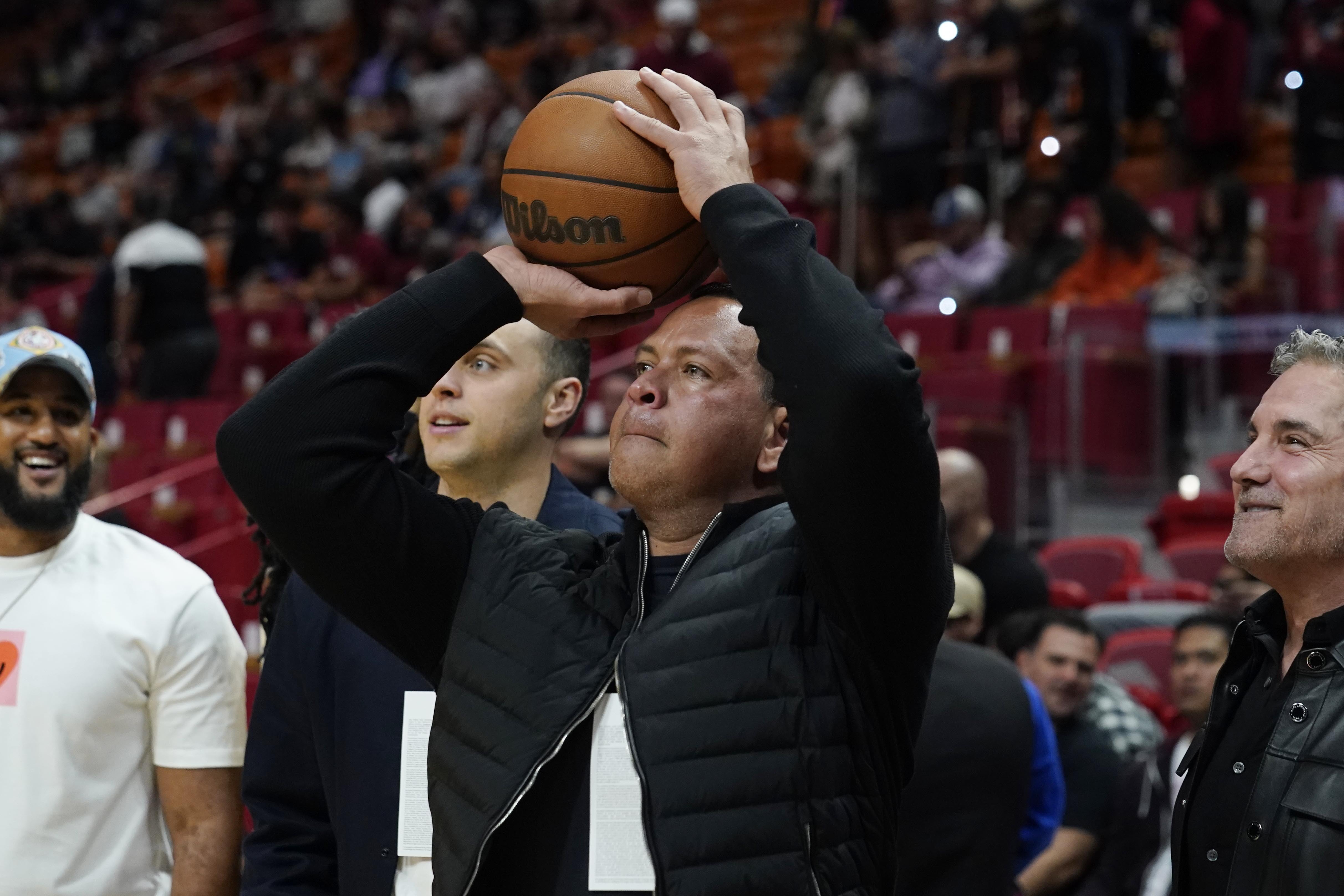 Alex Rodriguez, partial owner of the Minnesota Timberwolves NBA team aims a shot at the basket before the first half of an NBA basketball game against the Miami Heat, Saturday, March 12, 2022, in Miami. 