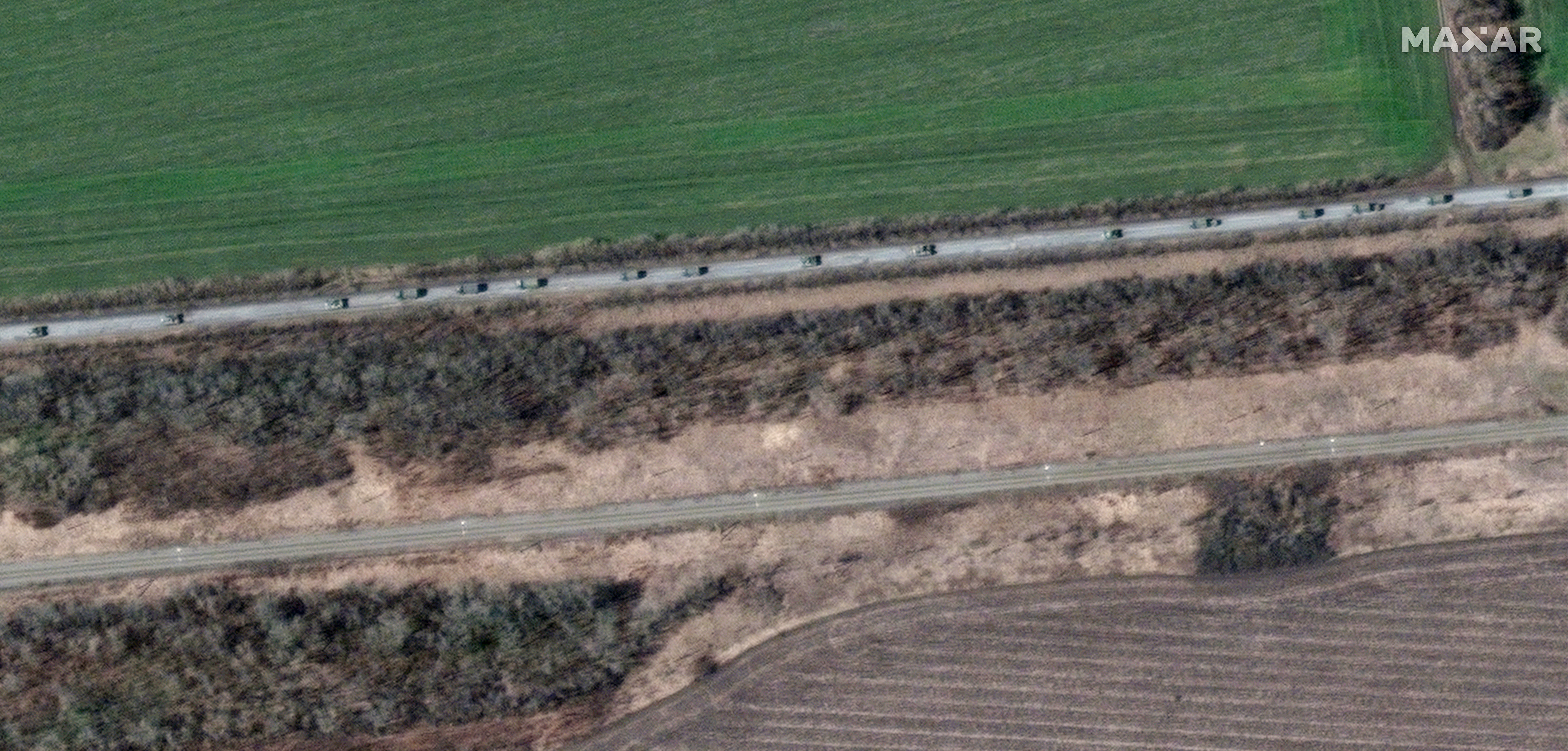 This satellite image provided by Maxar Technologies shows an overview of a convoy of armored vehicles and trucks moving the south, around Velykyi Burluk, east of Kharkiv, eastern Ukraine, on Friday.