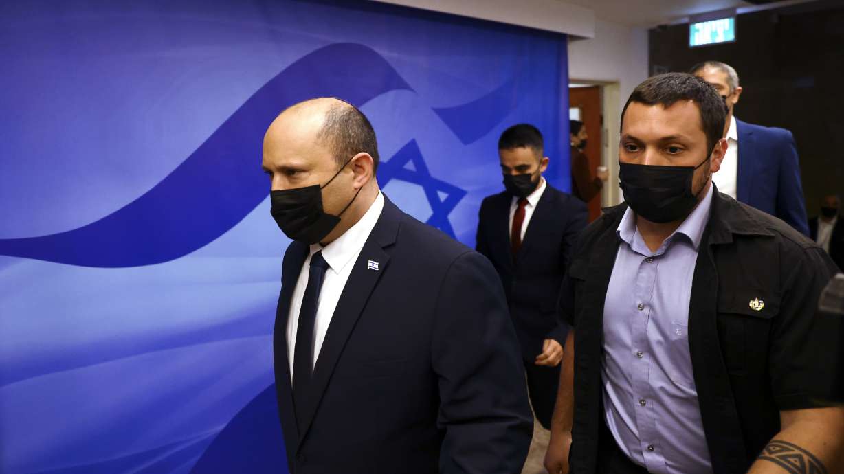 Israeli Prime Minister Naftali Bennett, left, attends a cabinet meeting at the Prime Minister's office in Jerusalem Sunday.