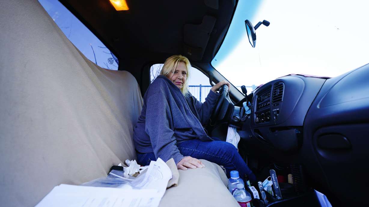 Karla Finocchio, 55, sits in her truck as she describes her days being homeless living in her truck, Feb. 4, 2022, in Phoenix. Finocchio is one face of America's graying homeless population, a rapidly expanding group of destitute and desperate people 50 and older suddenly without a permanent home after a job loss, divorce, family death or health crisis during a pandemic.