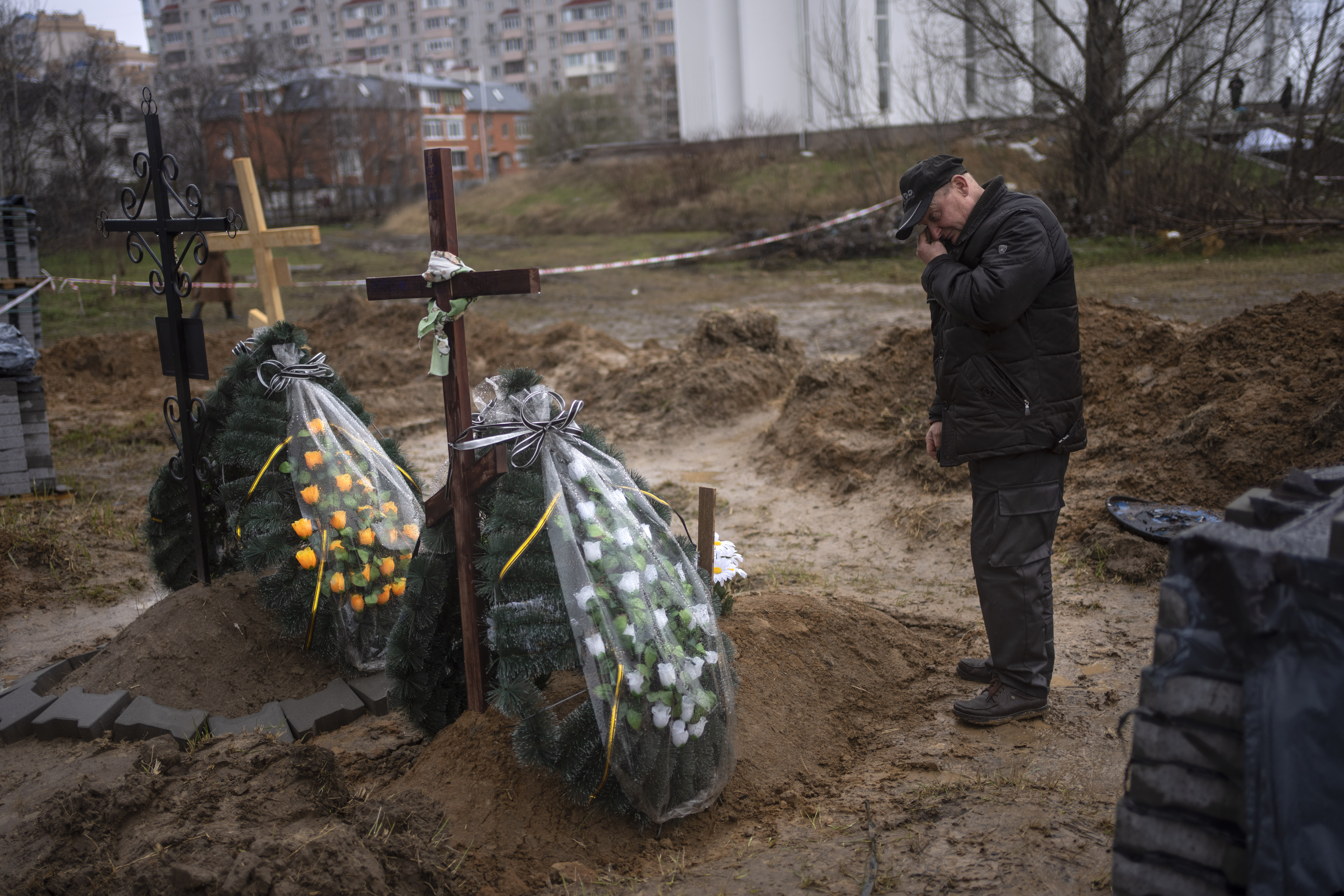 Oleg, 56, mourns for his mother Inna, 86, killed during the war against Russia in Bucha, in the outskirts of Kyiv, Ukraine, Sunday.