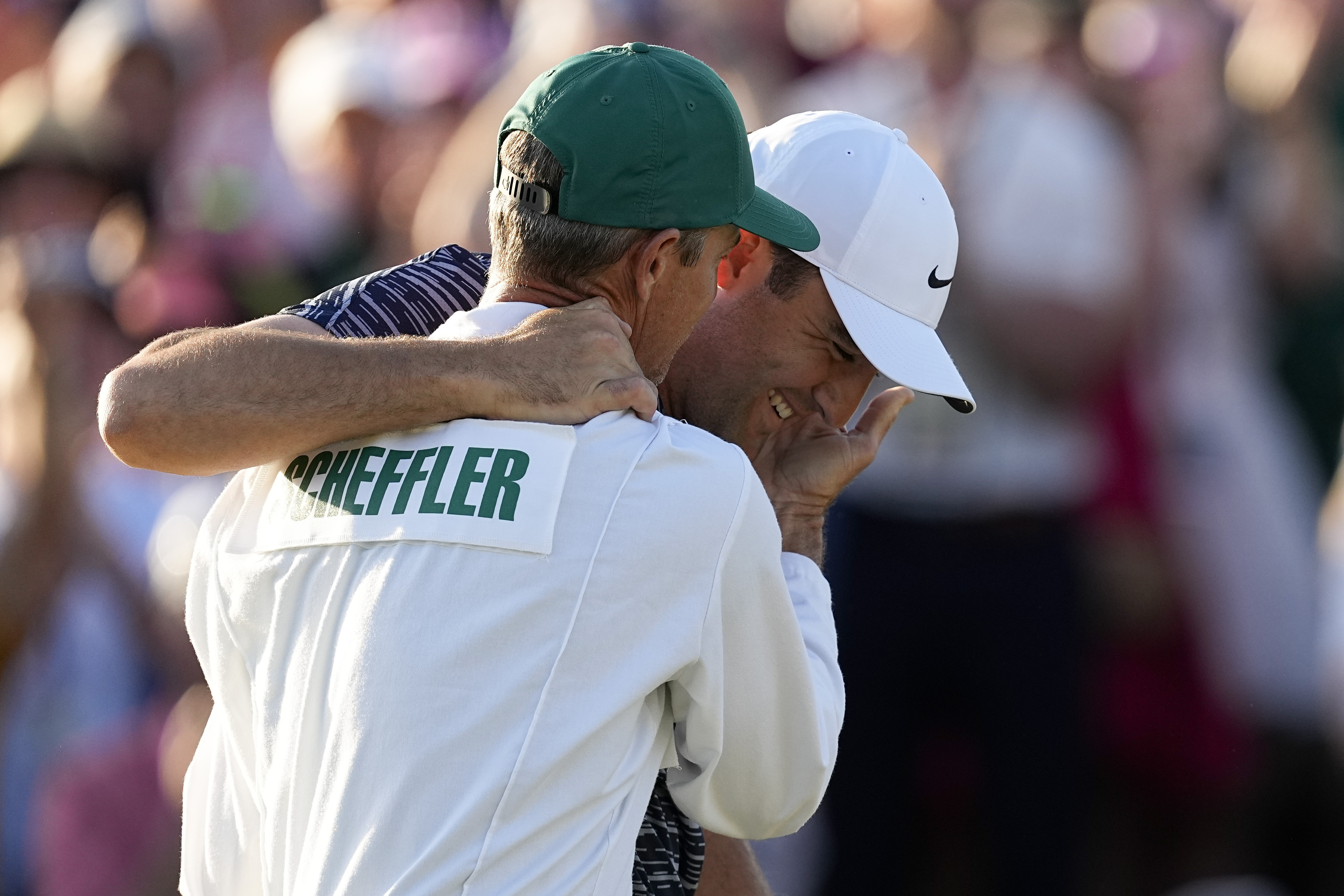 Scottie Scheffler hugs his caddie Ted Scott after winning the 86th Masters golf tournament on Sunday, April 10, 2022, in Augusta, Ga. 
