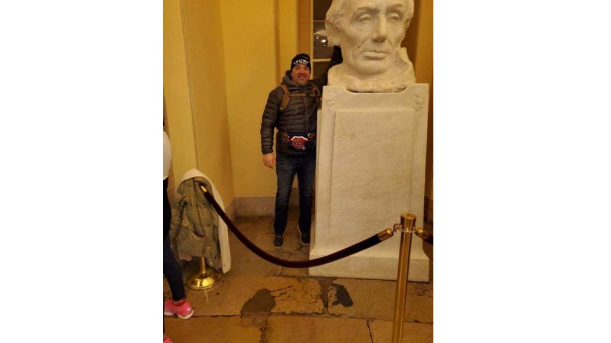 In a screenshot from Michael Hardin's federal complaint, a photo provided to the FBI by a tipster shows a man the tipster says is Hardin posing next to a bust of Abraham Lincoln in the Capitol Crypt on Jan. 6, 2021. The tipster told investigators they received the image from a relative of Hardin, who received it from Hardin directly.
