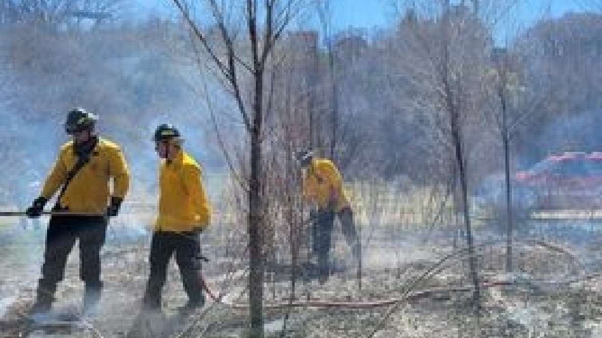 Sandy fire crews work to extinguish a fire at Dimple Dell Park. The mayor of Sandy took to social media on Monday to plead for information about three "suspicious" fires set in the park last week.