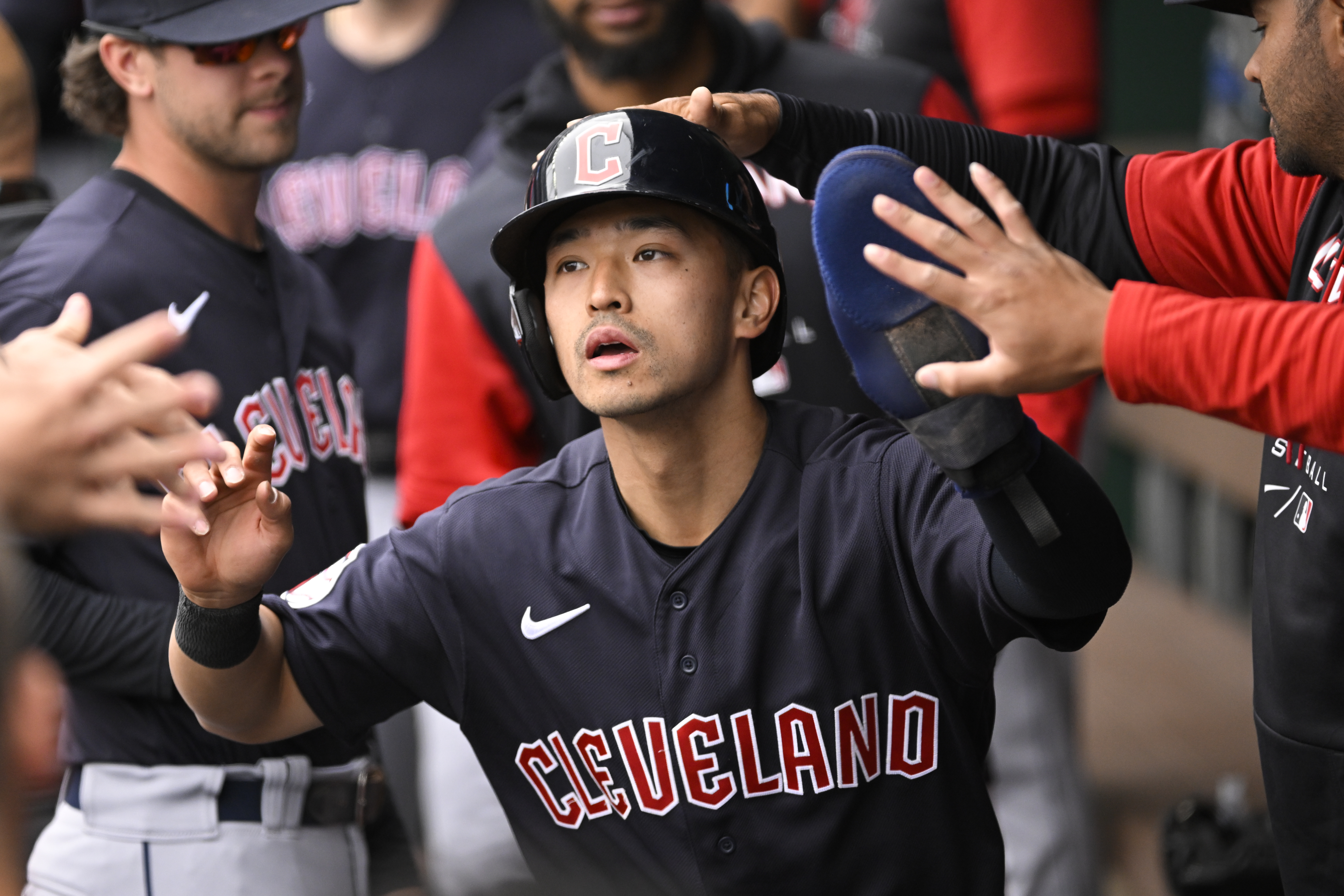 Cleveland Guardians' Steven Kwan is congratulated after scoring against the Kansas City Royals during the first inning of a baseball game, Monday, April 11, 2022, in Kansas City, Mo. 