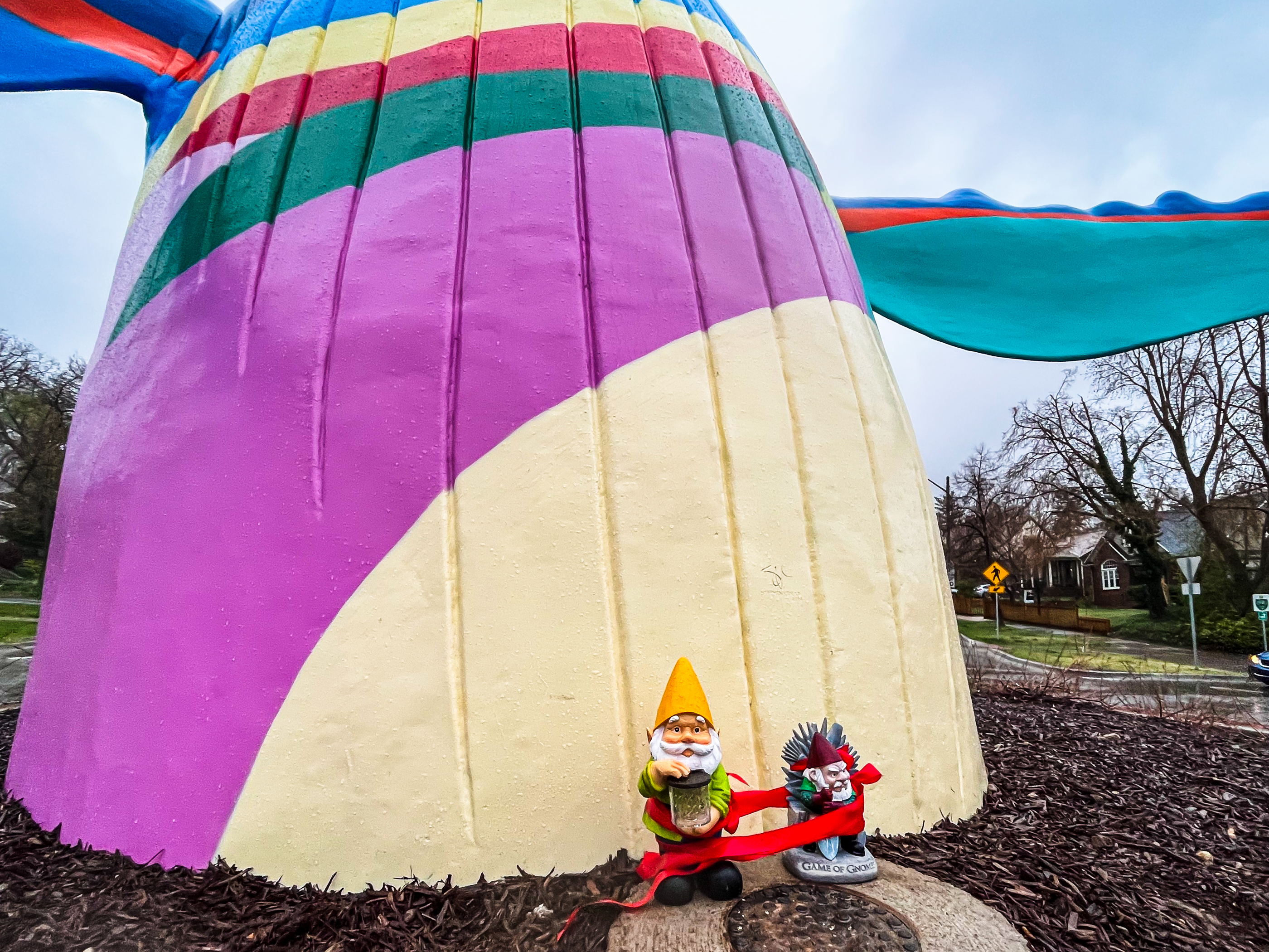 A pair of gnomes placed at the base of the 23-foot tall "Out of the Blue" sculpture in Salt Lake City on Monday evening.