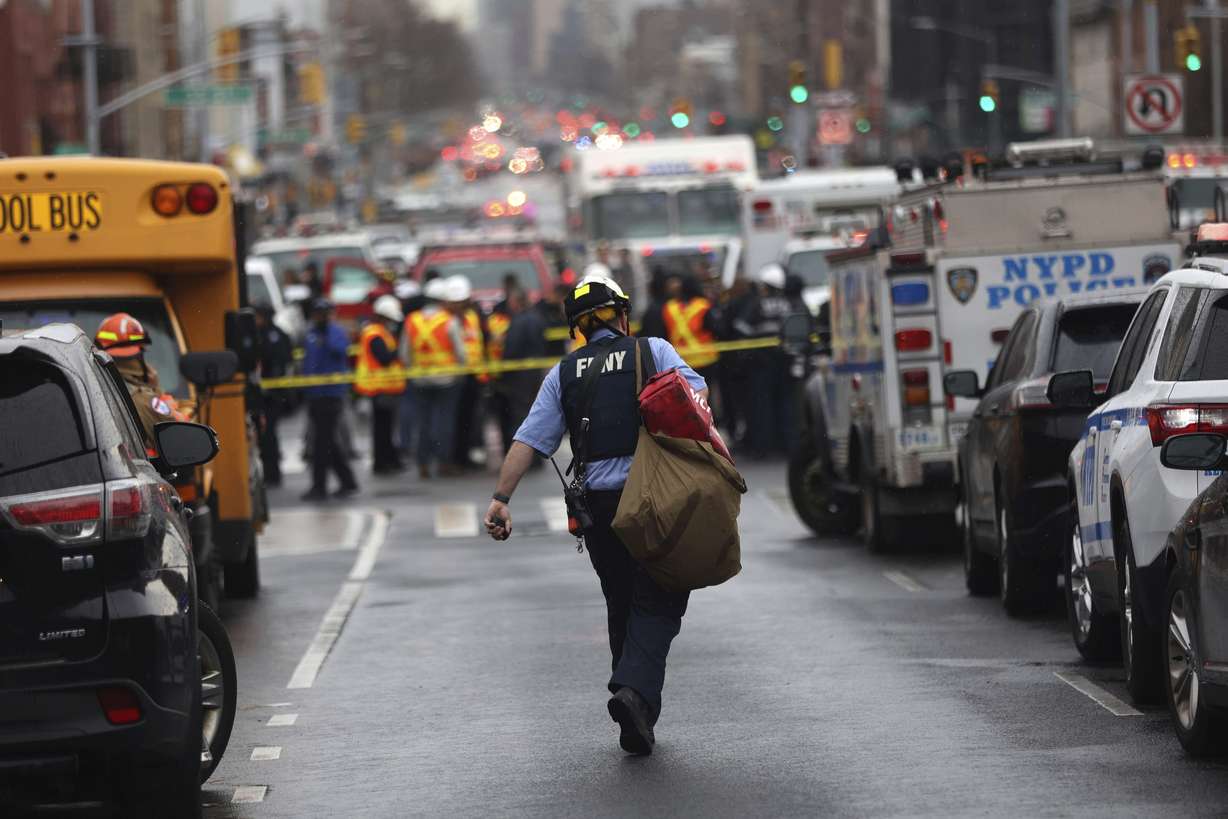 Law enforcement gather near the entrance to a subway stop in the Brooklyn borough of New York, Tuesday.