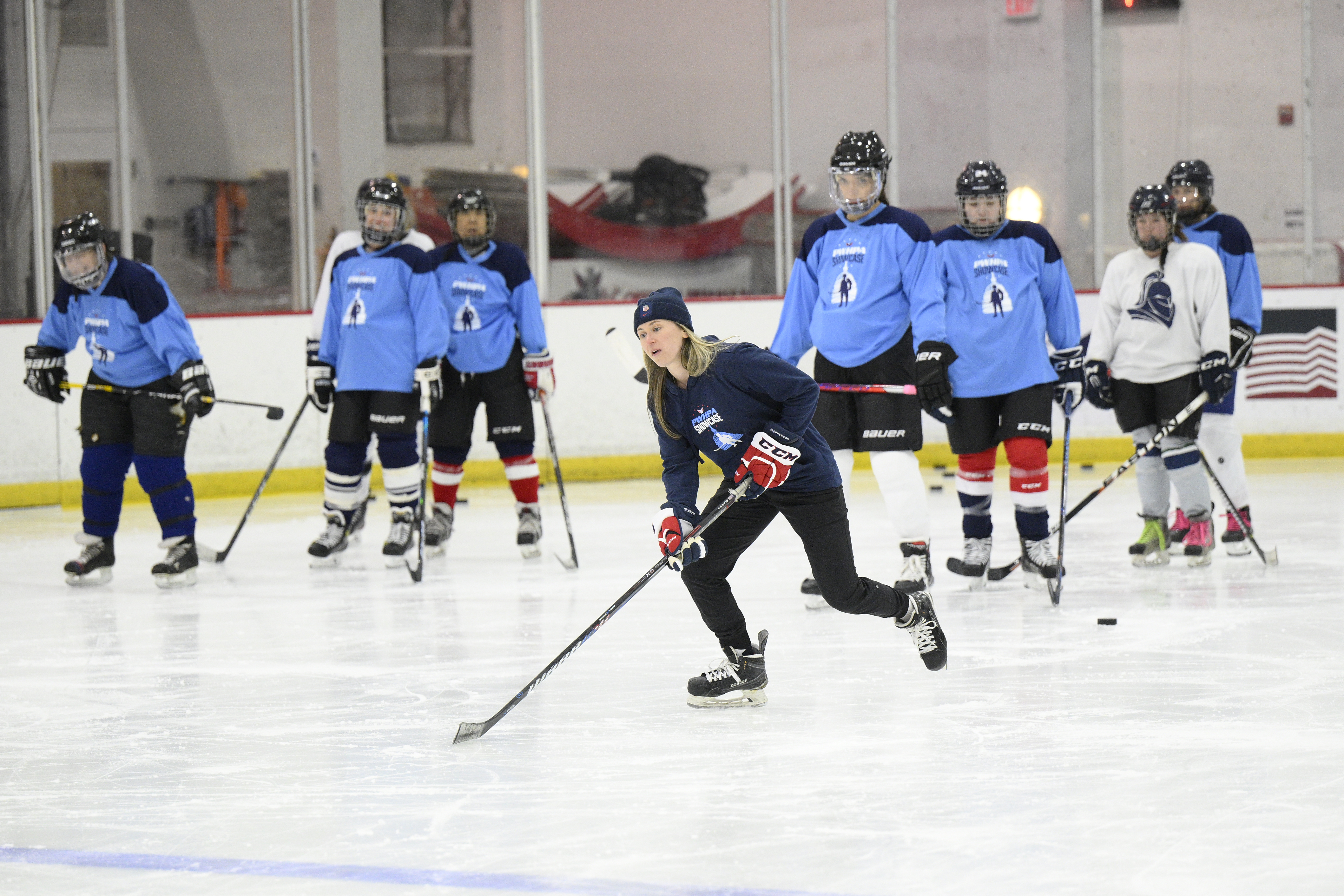 FILE - United States hockey player Haley Skarupa, front, demonstrates a drill during a hockey clinic presented by the Washington Capitals and the Professional Women's Hockey Players Association, Friday, March 4, 2022, in Arlington, Va. The Professional Women’s Hockey Players Association has decided to break off talks with the rival Premier Hockey Federation, the latest blow in a widening rift between two factions that contend they want to grow the sport in North America. The PWHPA executive board voted unanimously to end discussions with the PHF about collaborating, a person with knowledge of the situation told The Associated Press. The person spoke on condition of anonymity late Monday, April 11, 2022, because the decision had not been announced. 