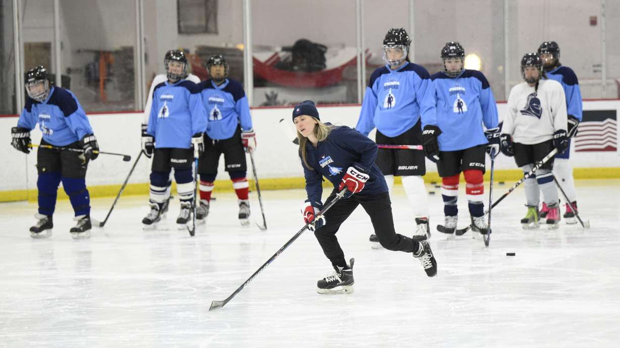 FILE - United States hockey player Haley Skarupa, front, demonstrates a drill during a hockey clinic presented by the Washington Capitals and the Professional Women's Hockey Players Association, Friday, March 4, 2022, in Arlington, Va. The Professional Women’s Hockey Players Association has decided to break off talks with the rival Premier Hockey Federation, the latest blow in a widening rift between two factions that contend they want to grow the sport in North America. The PWHPA executive board voted unanimously to end discussions with the PHF about collaborating, a person with knowledge of the situation told The Associated Press. The person spoke on condition of anonymity late Monday, April 11, 2022, because the decision had not been announced.
