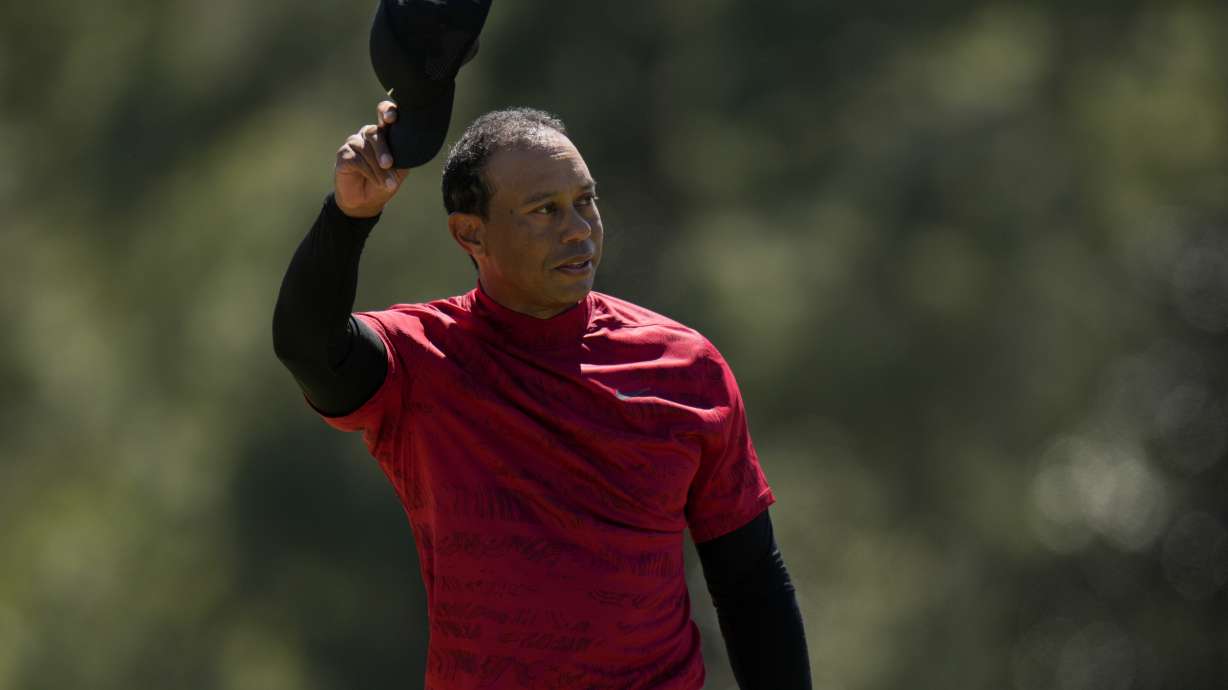 Tiger Woods tips his cap on the 18th green during the final round at the Masters golf tournament on Sunday, April 10, 2022, in Augusta, Ga.