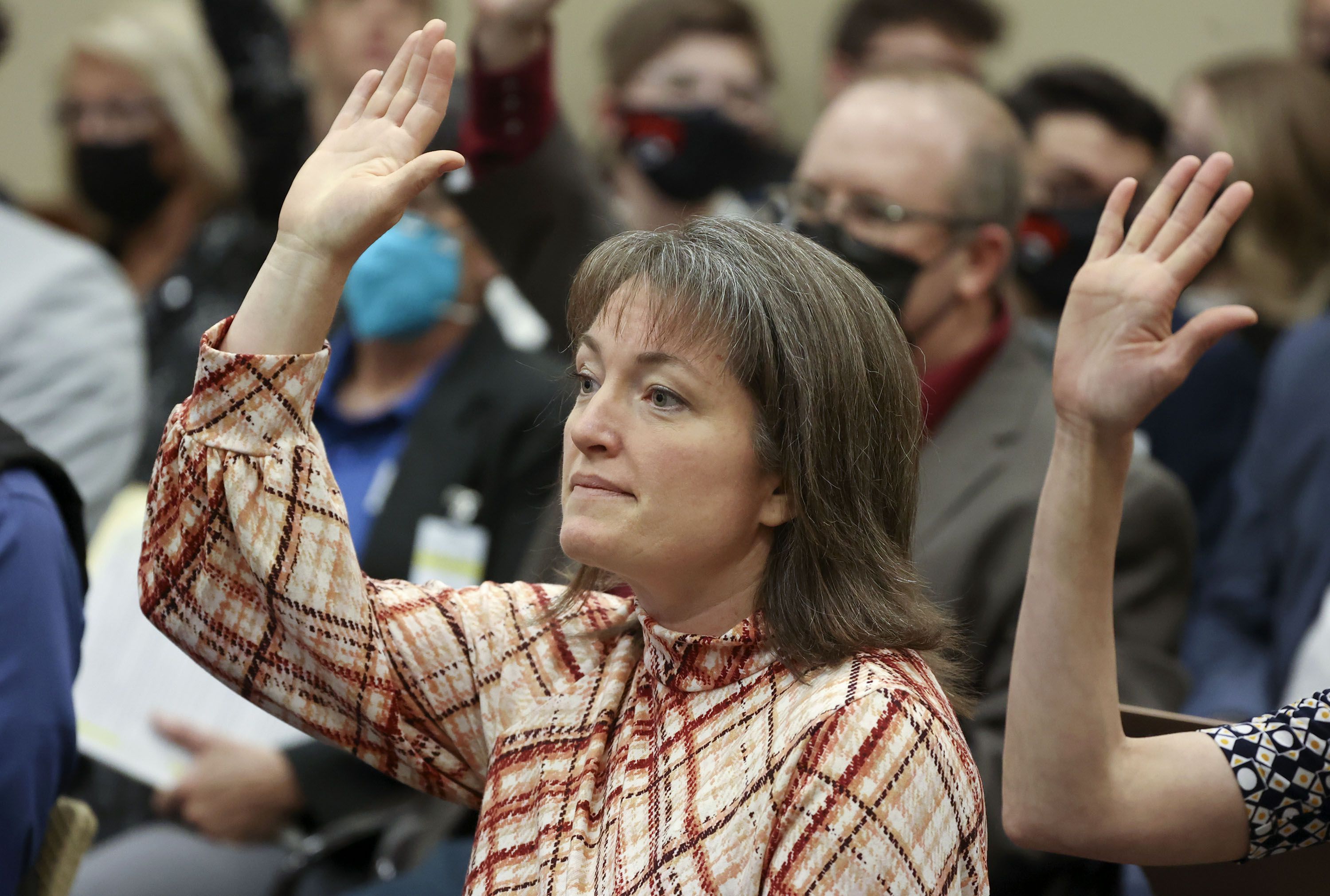 Worldwide Organization of Women President Nicholeen Peck raises her hand before giving public comment in support of SB114, Public School Curriculum Requirements, during a Senate Education Committee meeting in the Senate Building in Salt Lake City on Jan. 27.