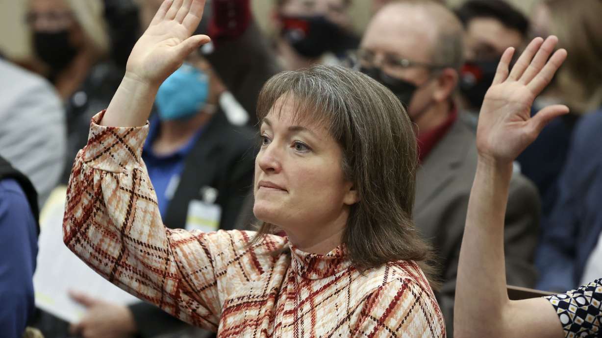 Worldwide Organization of Women President Nicholeen Peck raises her hand before giving public comment in support of SB114, Public School Curriculum Requirements, during a Senate Education Committee meeting in the Senate Building in Salt Lake City on Jan. 27.