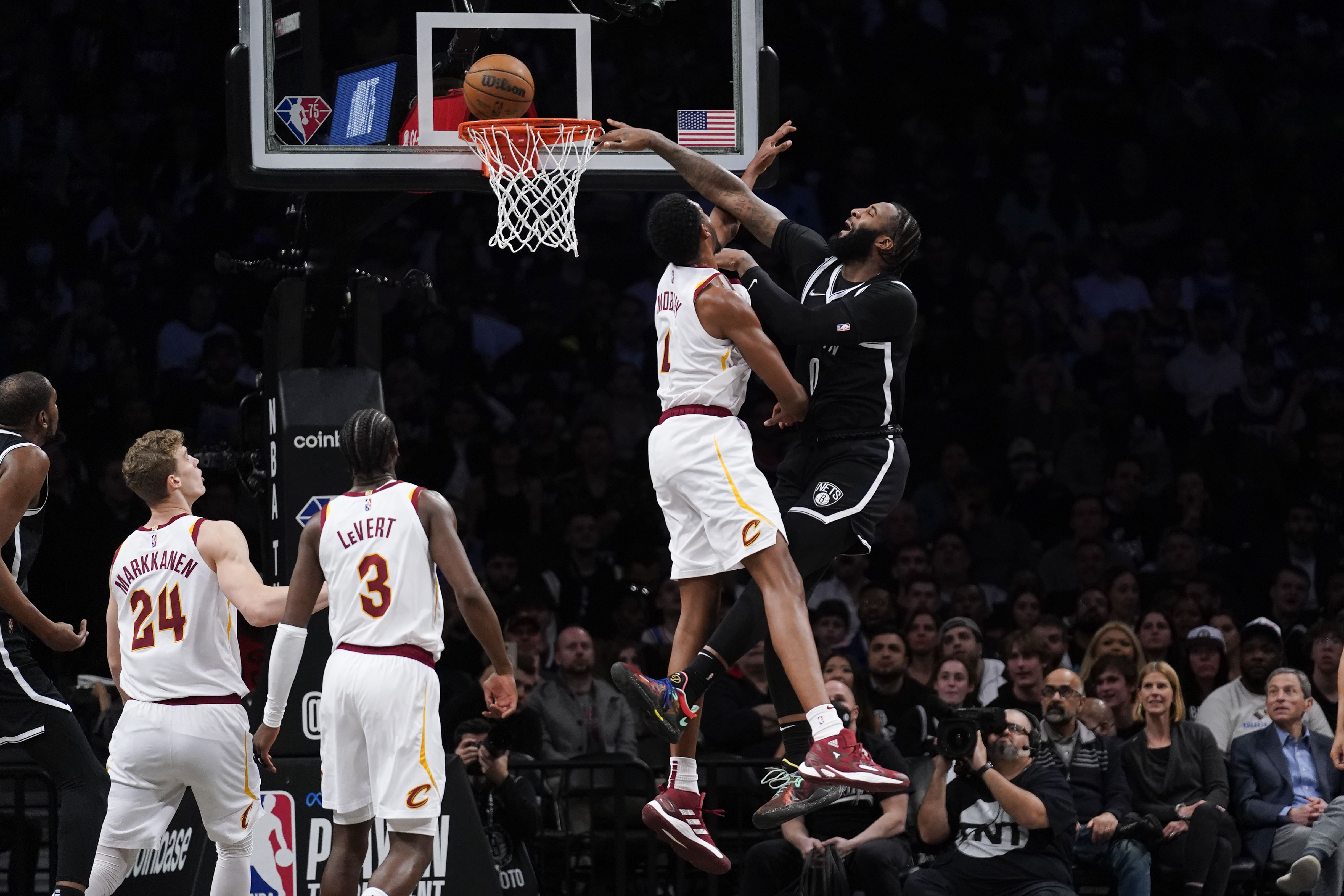 Brooklyn Nets' Andre Drummond, right, tries to dunk over Cleveland Cavaliers' Evan Mobley during the first half of the opening basketball game of the NBA play-in tournament Tuesday, April 12, 2022, in New York. 