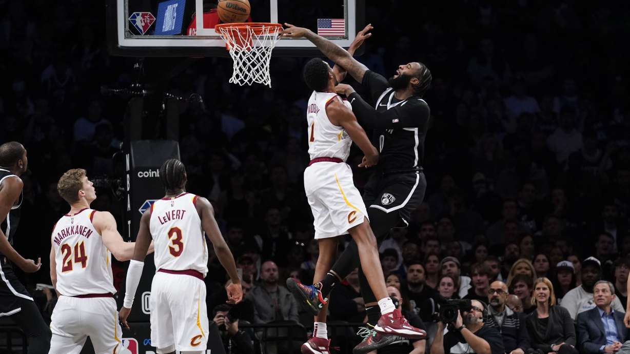 Brooklyn Nets' Andre Drummond, right, tries to dunk over Cleveland Cavaliers' Evan Mobley during the first half of the opening basketball game of the NBA play-in tournament Tuesday, April 12, 2022, in New York.