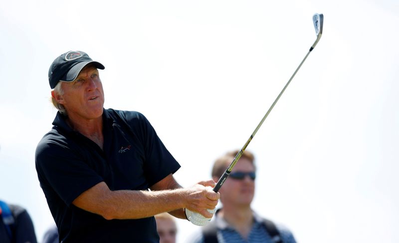 FILE PHOTO: Greg Norman of Australia watches his tee shot on the sixth hole during a practice round ahead of the British Open Golf Championship at the Turnberry Golf Club in Scotland, July 15, 2009.