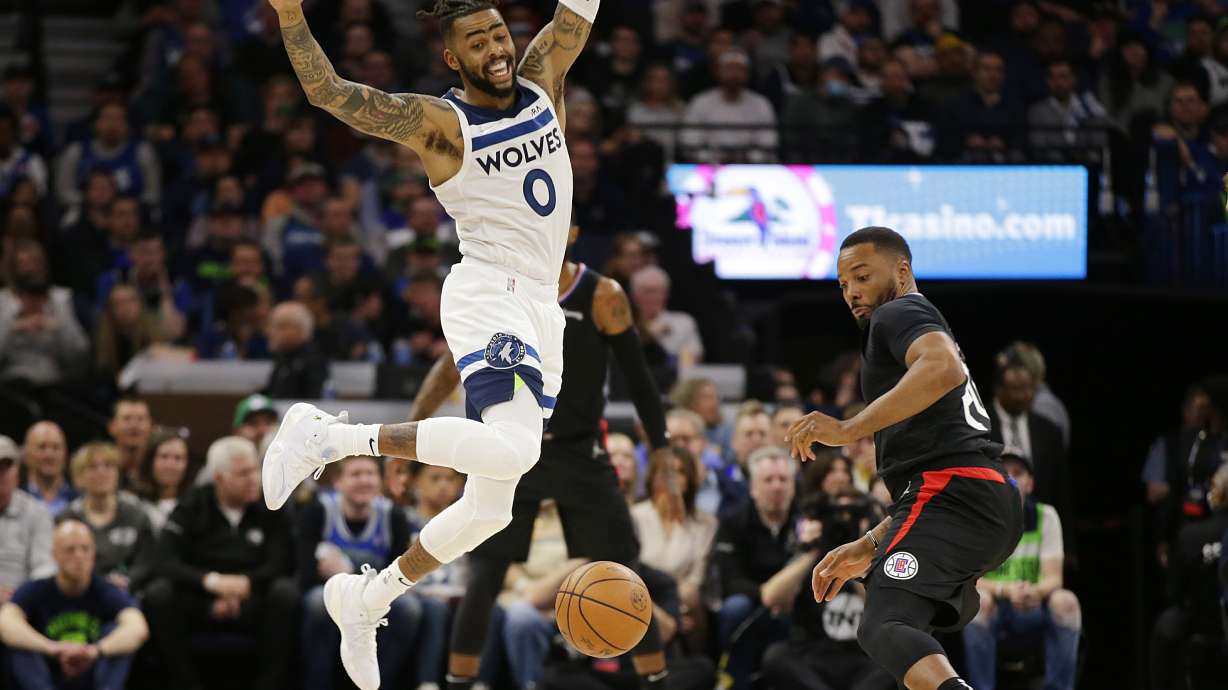 Minnesota Timberwolves guard D'Angelo Russell (0) loses control of the ball while Los Angeles Clippers forward Norman Powell (24) defends during the first quarter during an NBA basketball game Tuesday, April 12, 2022, in Minneapolis.