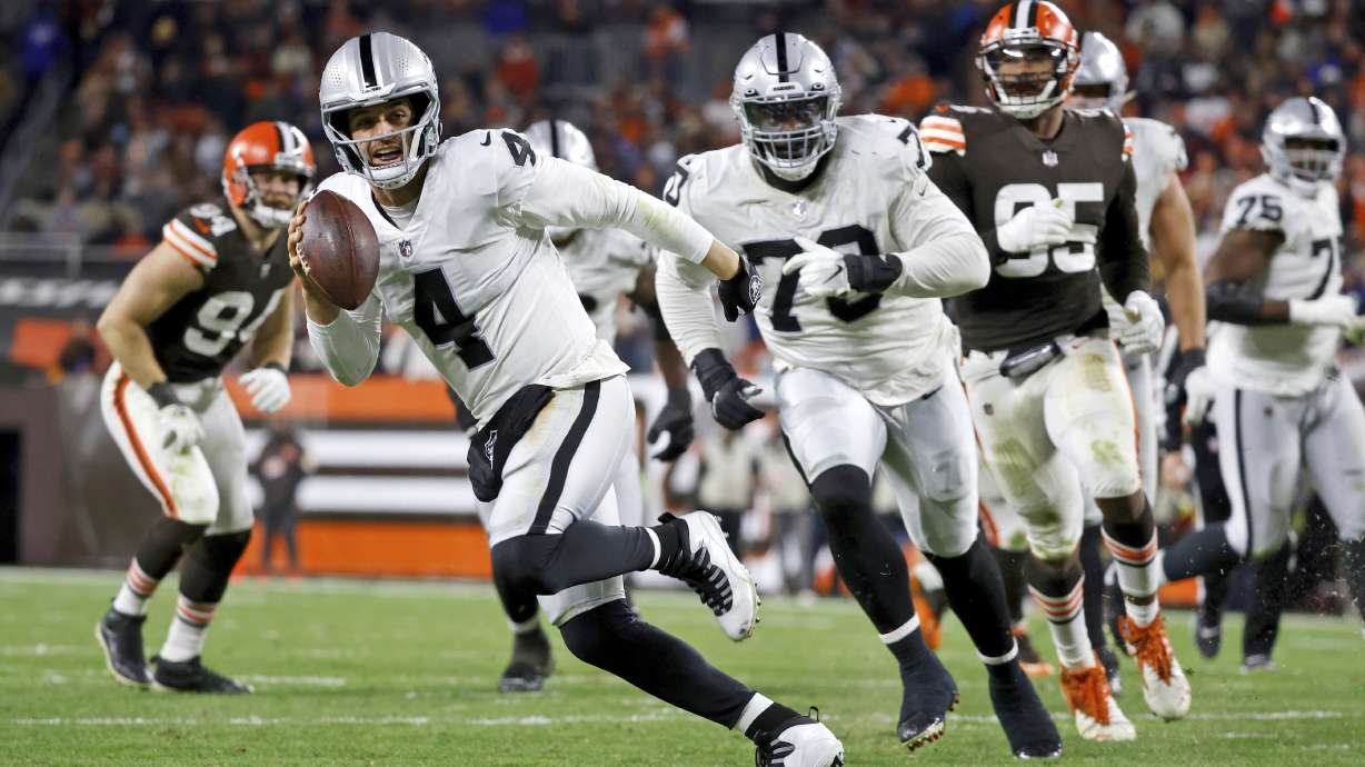 FILE - Las Vegas Raiders quarterback Derek Carr runs with the ball during an NFL football game against the Cleveland Browns on Monday, Dec. 20, 2021, in Cleveland. The Raiders have given Carr a three-year contract extension, a person with knowledge of the deal tells The Associated Press. The extension is worth $121.5 million, the person said, speaking Wednesday, April 13, 2022, on condition of anonymity because the deal has not been announced. (AP Photo/Kirk Irwin, File0