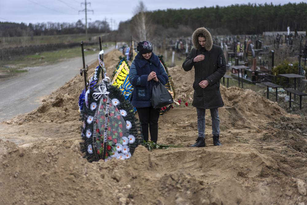 Natalya Verbova, 49, and her son Roman Verbovyi, 23, attend the funeral of her husband Andriy Verbovyi, 55, who was killed by Russian soldiers while serving in Bucha territorial defense, in the outskirts of Kyiv, Ukraine, Wednesday.