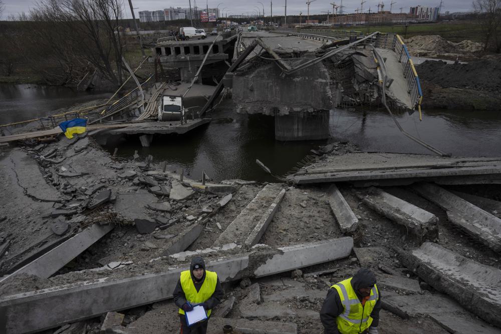 Engineers inspect the state of destruction of the bridge that connects Kyiv with Irpin, Ukraine, Wednesday. The presidents of four countries on Russia's doorstep have underscored their support for Ukraine in a visit to the embattled country.