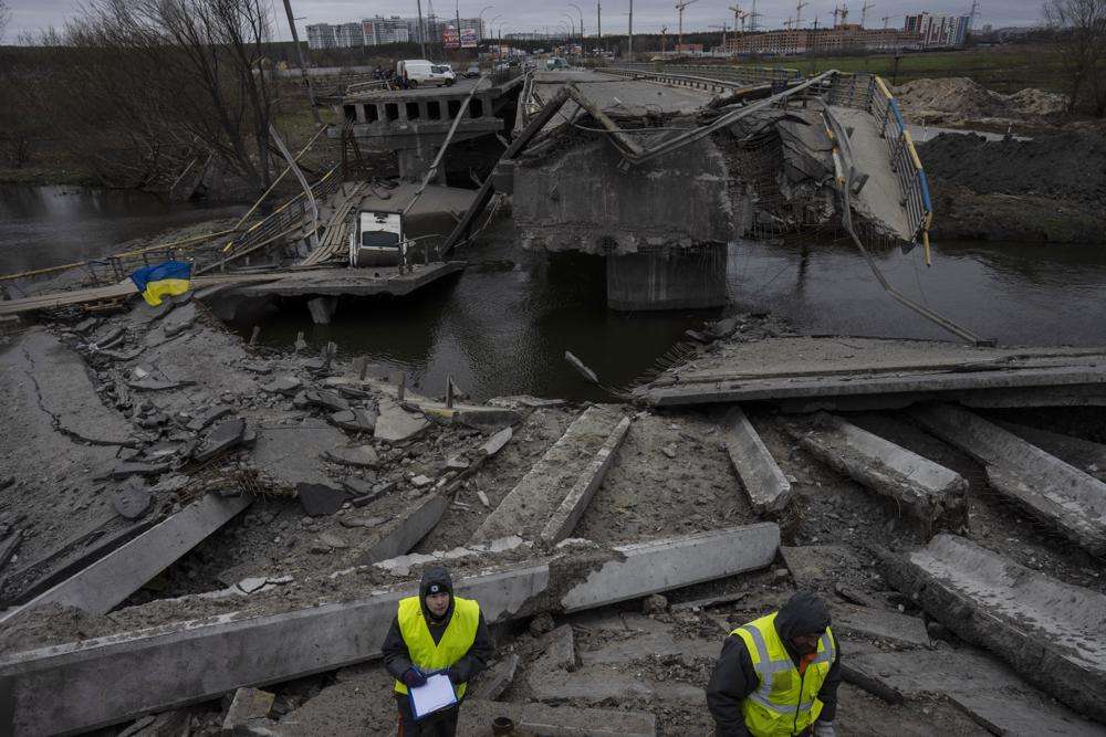 Engineers inspect the state of destruction of the bridge that connects Kyiv with Irpin, Ukraine, Wednesday. The presidents of four countries on Russia's doorstep have underscored their support for Ukraine in a visit to the embattled country.
