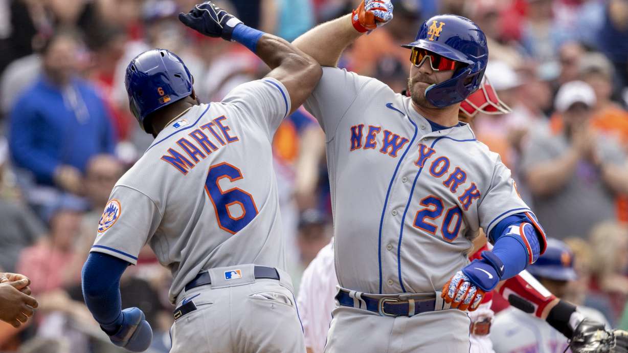 New York Mets' Pete Alonso (20) celebrates with Starling Marte (6) after hitting a 3-run home run during the sixth inning of a baseball game against the Philadelphia Phillies, Wednesday, April 13, 2022, in Philadelphia.