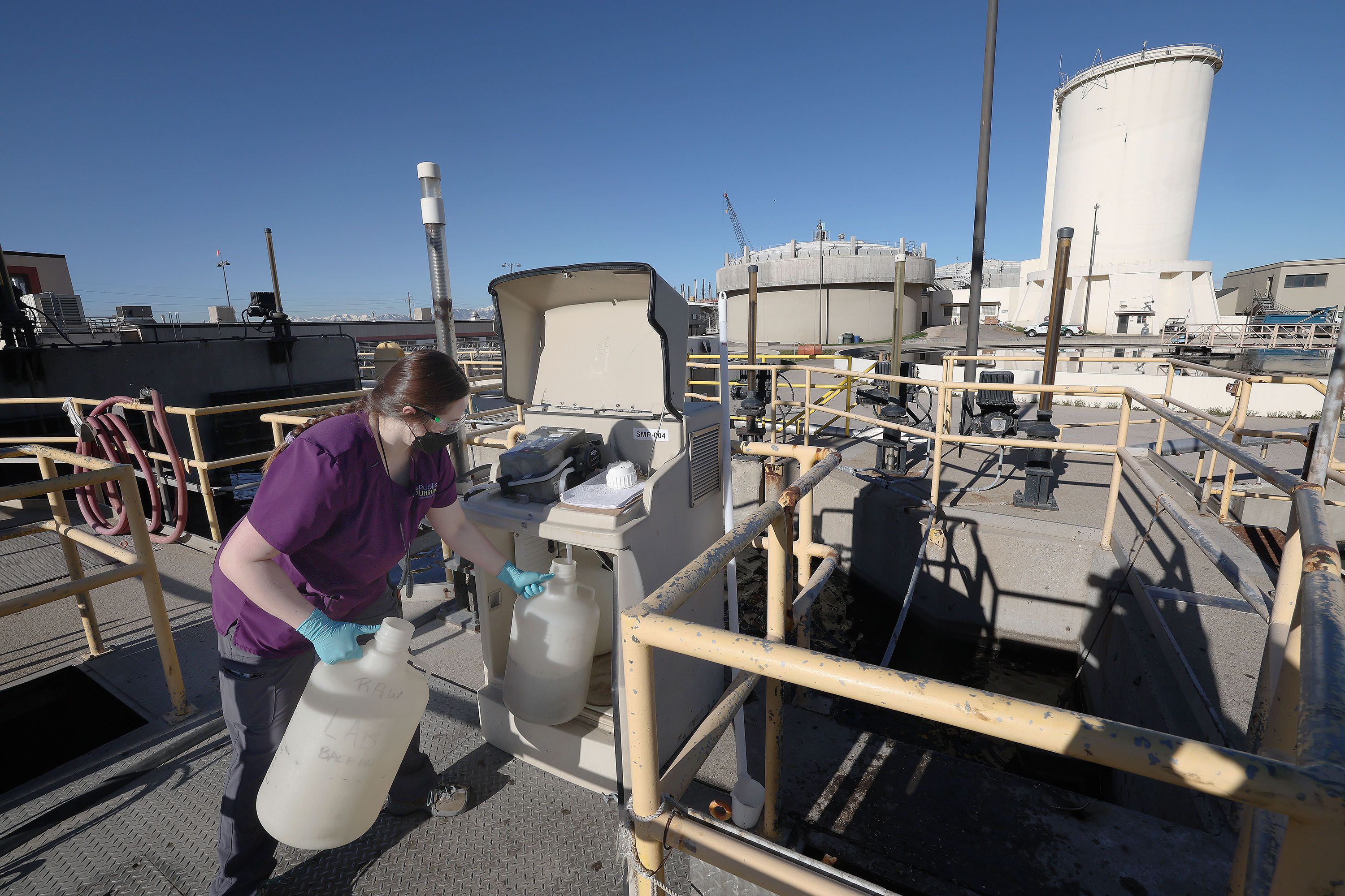 Maddi Crezee gets a sample of raw sewage at the Salt Lake City Water Reclamation Facility in Salt Lake City on April 6. The water at the facility is tested for COVID-19 twice a week.