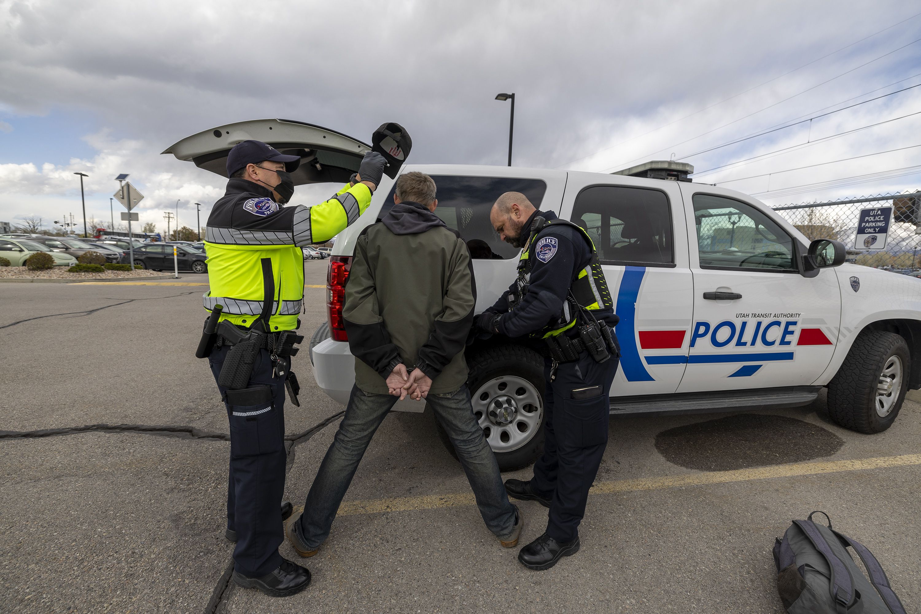 Utah Transit Authority police officers Phil Herrera and John Lobaido search a man they removed from a TRAX train after they verified he had felonies as they checked tickets in the Murray area on Wednesday.