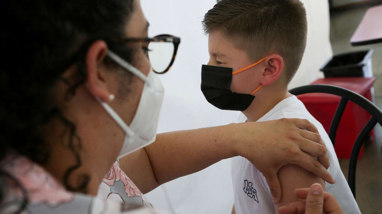 A child is administered a dose of the Pfizer-BioNTech coronavirus disease pediatric vaccine, in San Jose, Costa Rica, Feb. 23. A third dose of the Pfizer-BioNTech's COVID-19 vaccine produced significant protection against the omicron variant in healthy children aged between 5 and 11 years, the companies say.