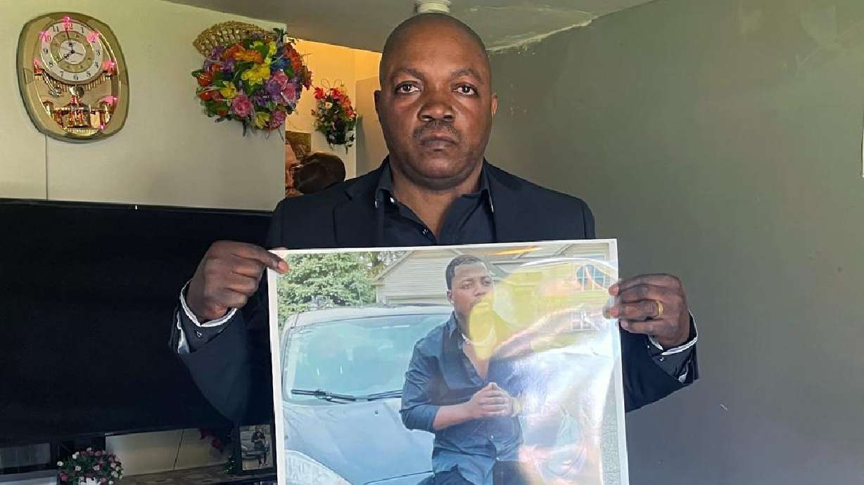 Peter Lyoya holds up a picture of his son Patrick Lyoya, 26, in his home in Lansing, Mich., Thursday. Grand Rapids police released four videos from different sources Wednesday, nine days after Patrick Lyoya was killed during a traffic stop.