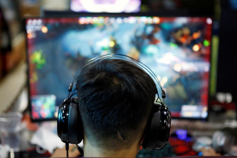 FILE PHOTO: A man plays online game on a computer at an internet cafe in Beijing, China August 31, 2021.
