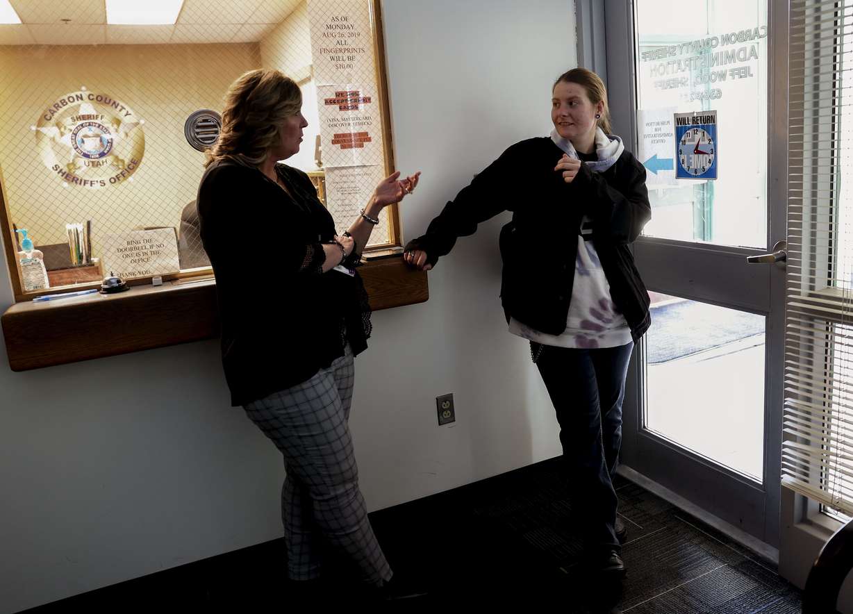 Carbon County victim advocate Denna Fausett, left, and Josie Powell, right, talk at the Carbon County Sheriff’s Office in Price on Tuesday. Powell and Fausett met three years ago when Powell was reported being brutally sexually assaulted by her then-boyfriend. Since then Fausett has become “like family” to Powell.