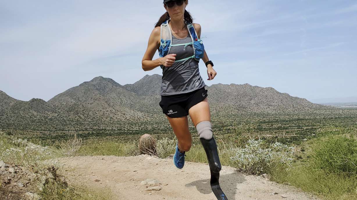 In this image provided by Edwin Broersma, marathoner Jacky Hunt-Broersma trains on Aug. 28, 2021 at San Tan Mountain Regional Park, in San Tan Valley, Az. Hunt-Broersma lost her left leg below the knee to a rare form of cancer, but she hasn't let that stop her and is trying to cover the classic 26.2-mile marathon distance at least 102 times in 102 days, which would set a new world record. The Boston Marathon on April 18 is expected to be No. 92 in her streak.