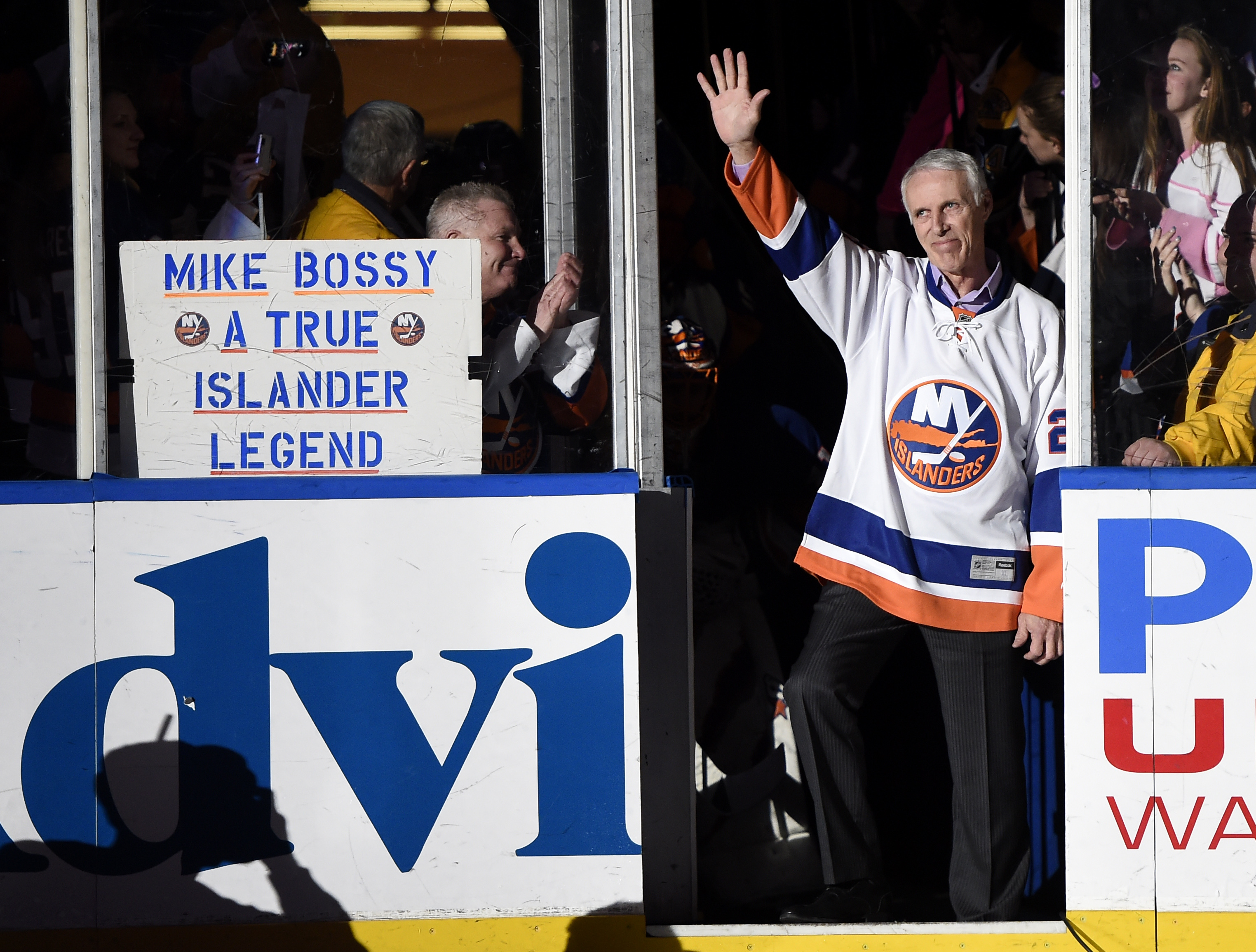 FILE - Hockey Hall of Famer and former New York Islander Mike Bossy waves to fans as he is introduced before the NHL hockey game between the Islanders and the Boston Bruins at Nassau Coliseum on Thursday, Jan. 29, 2015, in Uniondale, N.Y. Bossy dropped a ceremonial first puck. Bossy, one of hockey’s most prolific goal-scorers and a star for the New York Islanders during their 1980s dynasty, died Friday, April 15, 2022, after a battle with lung cancer. He was 65. 