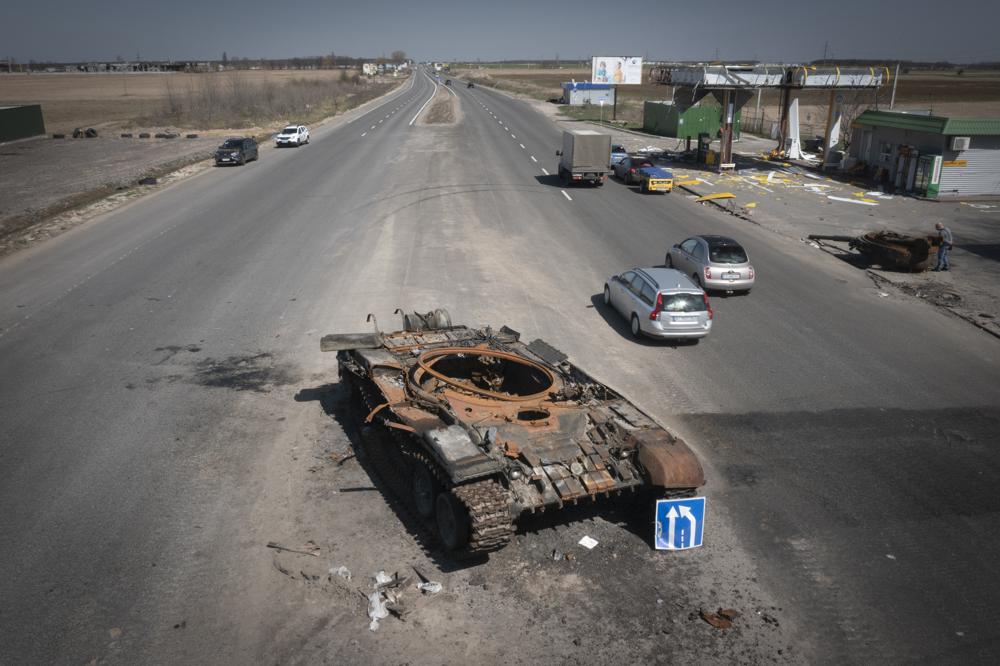 A Russian tank destroyed in recent fighting is seen on a road to Kyiv, Ukraine, Friday. More than 900 bodies of civilians were discovered in the Kyiv region following the withdrawal of Russian forces.