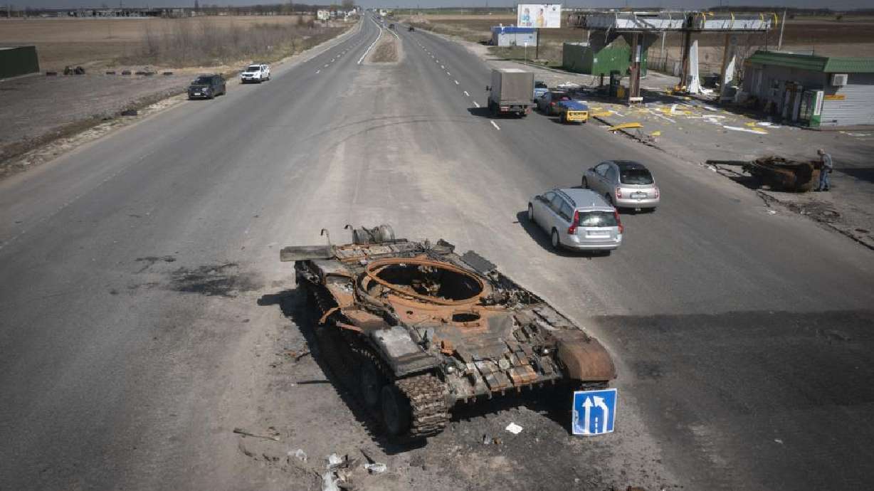 A Russian tank destroyed in recent fighting is seen on a road to Kyiv, Ukraine, Friday. More than 900 bodies of civilians were discovered in the Kyiv region following the withdrawal of Russian forces.