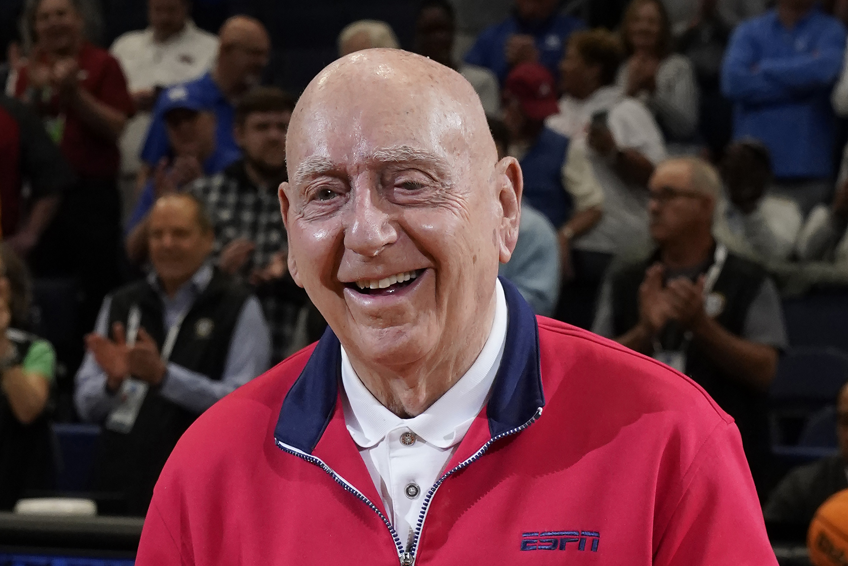 FILE - ESPN sportscaster Dick Vitale poses before an NCAA college basketball game between between Texas A&M and Arkansas at the Southeastern Conference tournament Saturday, March 12, 2022, in Tampa, Fla. Longtime college basketball broadcaster Dick Vitale is celebrating after finishing chemotherapy at Sarasota Memorial Hospital in Florida. He tweeted Thursday, April 14, 2022, that he was cancer-free, and posted a video of himself ringing the bell in excitement.