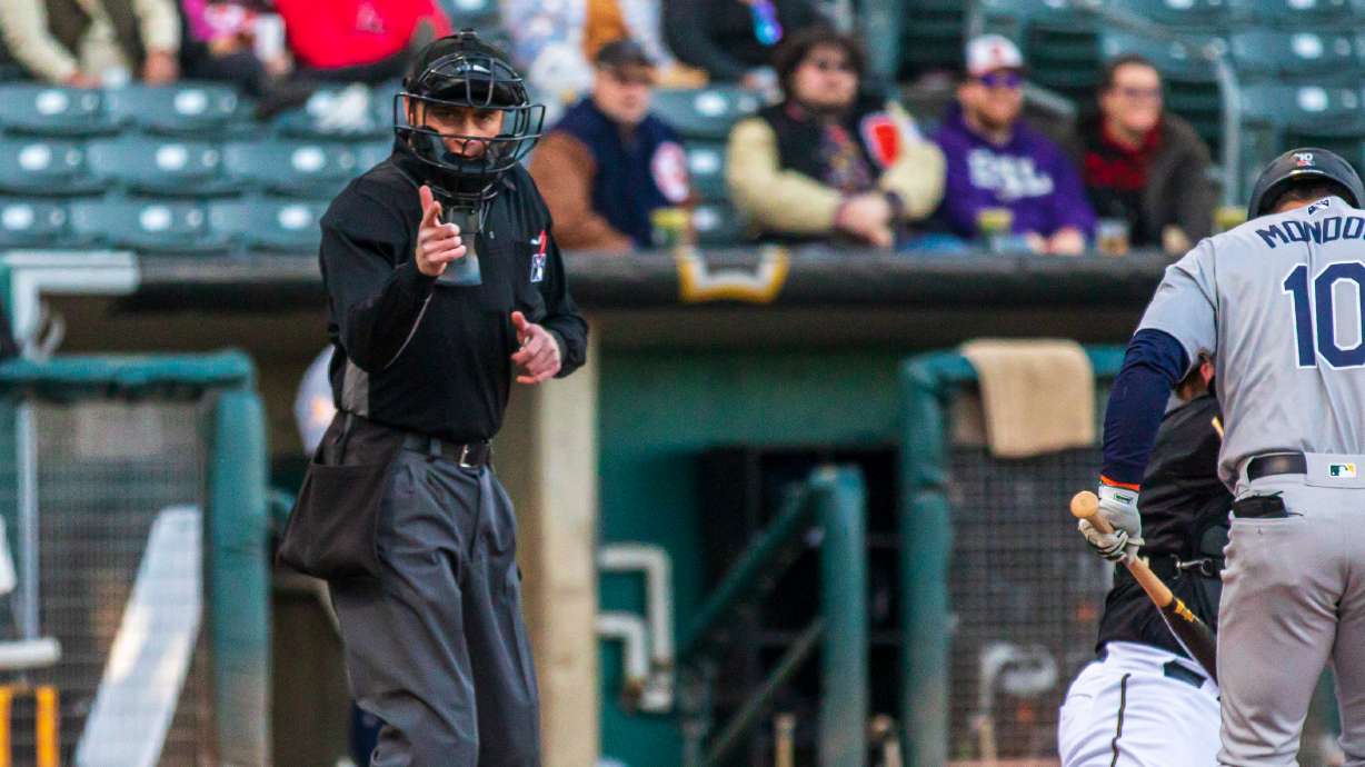 Home plate umpire Darius Ghani calls a strike during a Salt Lake Bees games at Smith's Ballpark Friday evening. Robot strike zones will be implemented in mid-May.
