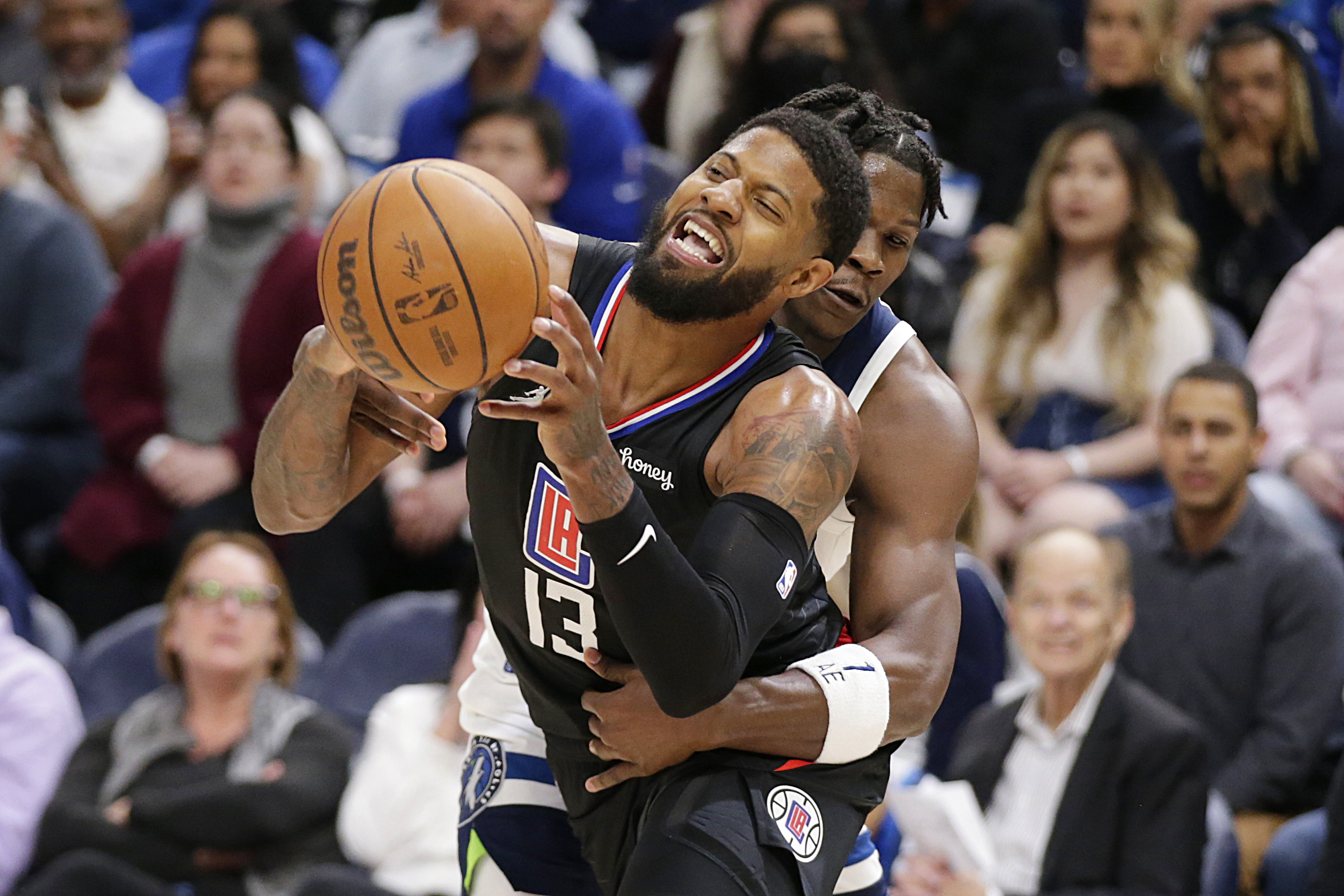 Los Angeles Clippers guard Paul George (13) is fouled by Minnesota Timberwolves forward Anthony Edwards during the second quarter during an NBA basketball game Tuesday, April 12, 2022, in Minneapolis. 