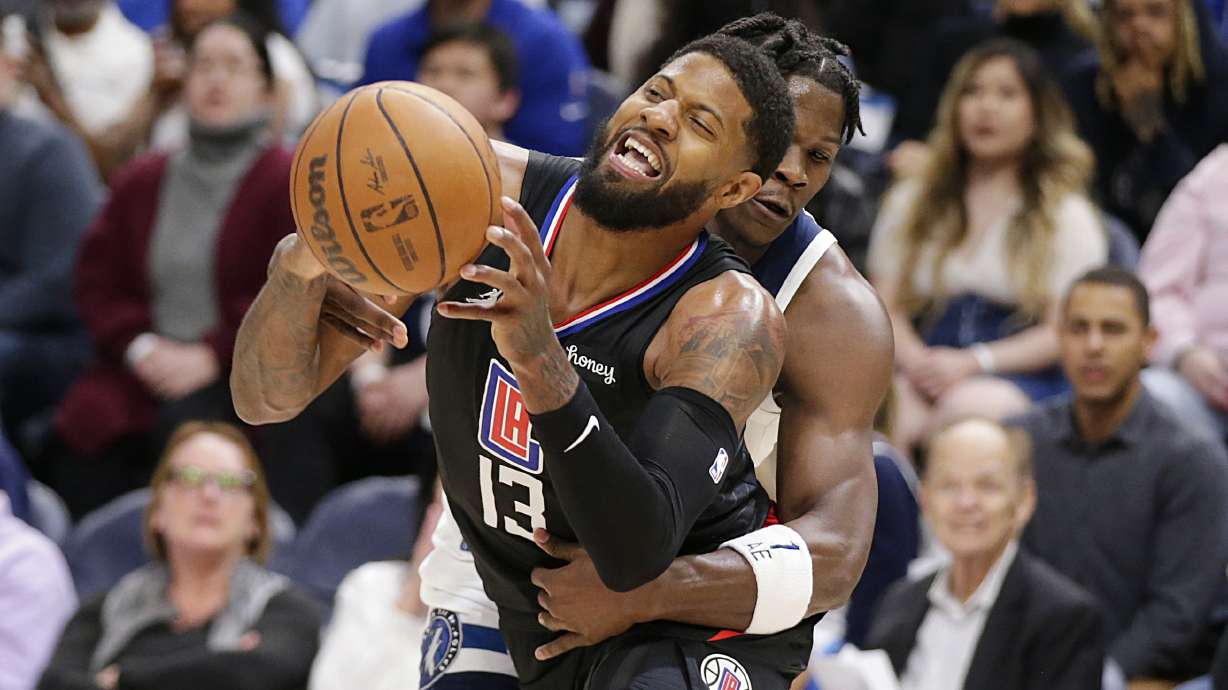 Los Angeles Clippers guard Paul George (13) is fouled by Minnesota Timberwolves forward Anthony Edwards during the second quarter during an NBA basketball game Tuesday, April 12, 2022, in Minneapolis.
