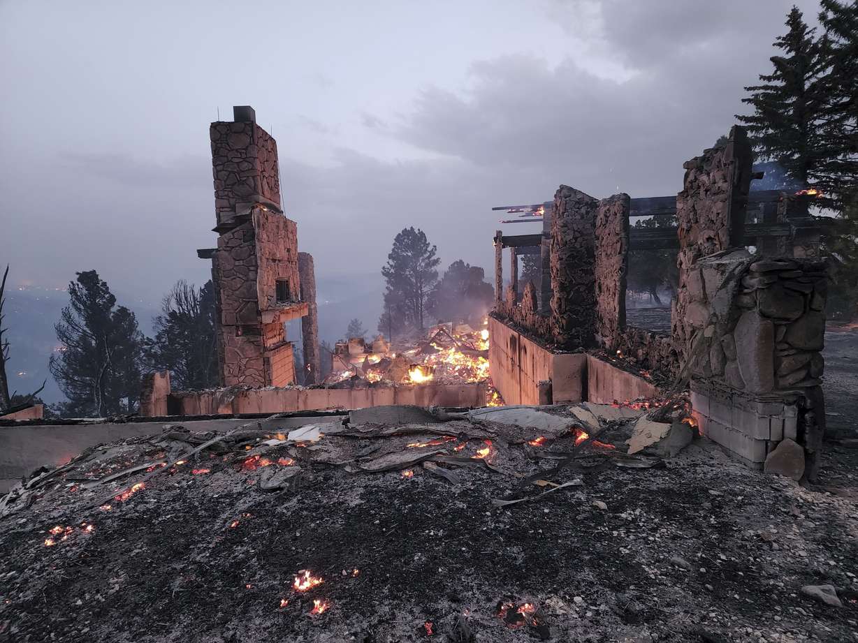 The remains of a home left after a wildfire spread through the Village of Ruidoso, New Mexico, on Wednesday. Officials say a wildfire has burned about 150 structures, including homes, in the New Mexico town of Ruidoso.